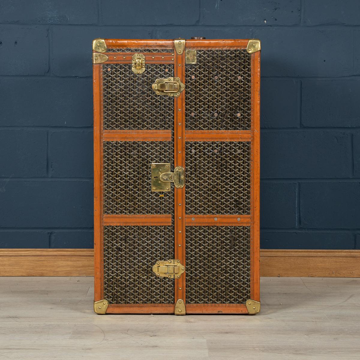 A huge Goyard wardrobe trunk in fabulous condition, completely original and with great character, opening (with a flip top cover) to reveal a hanging compartment to the left and a set of drawers to the right hand side. Dating to the early part of