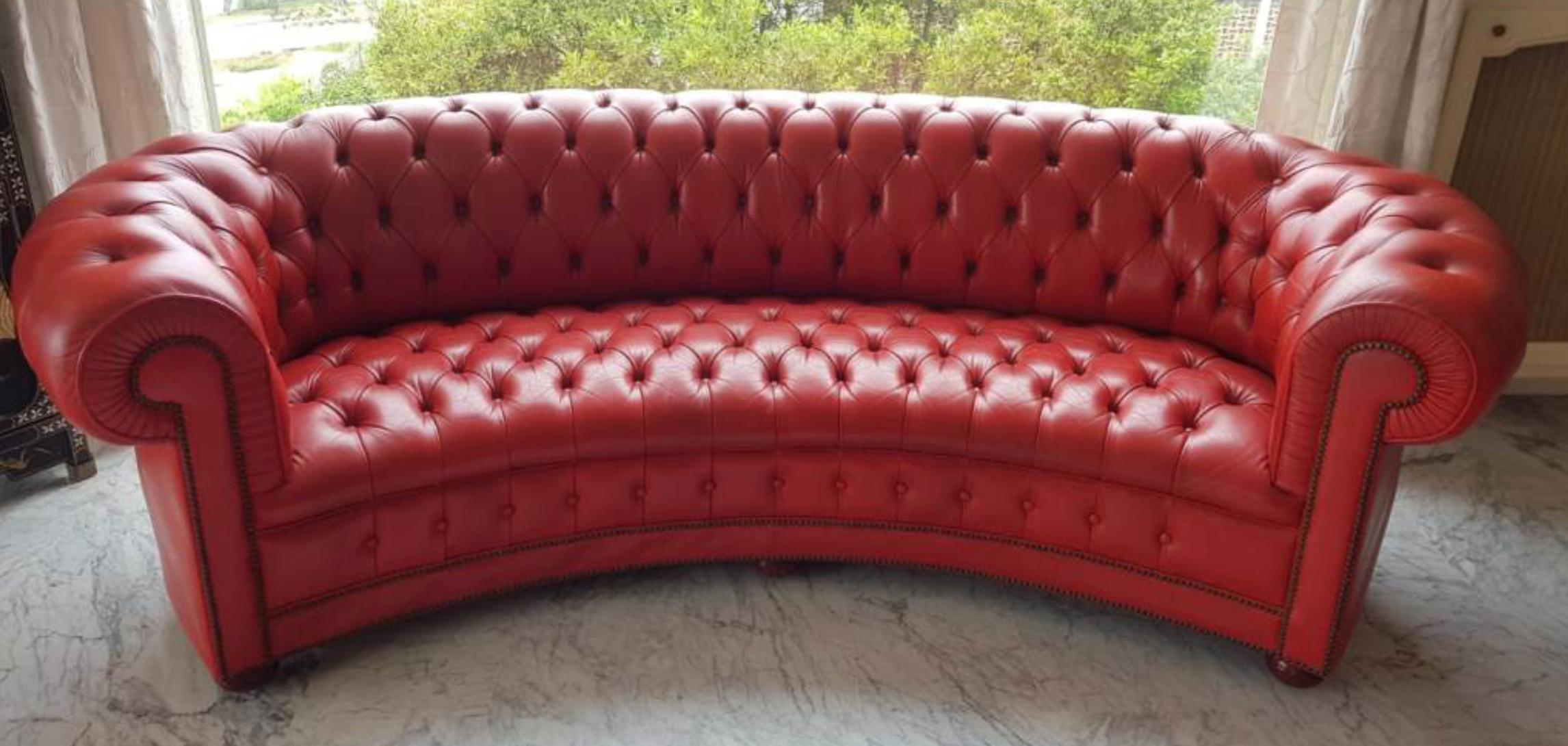 Chesterfield leather oval canapé in beautiful vivid red color and in great condition. It is standing on six wooden lex with hidden metal casters in order to be moved easily.
England, circa 1970.