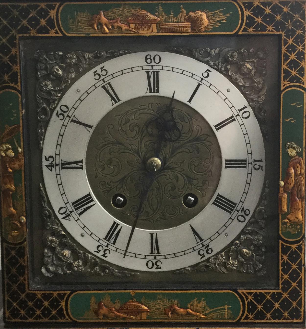 An attractive green chinoiserie Georgian style mantel clock, circa 1920, the case profusely decorated in relief with garden scenes, figures, pagodas and floral motifs, the top with brass handle, on brass bun feet.

The brass face with engraved