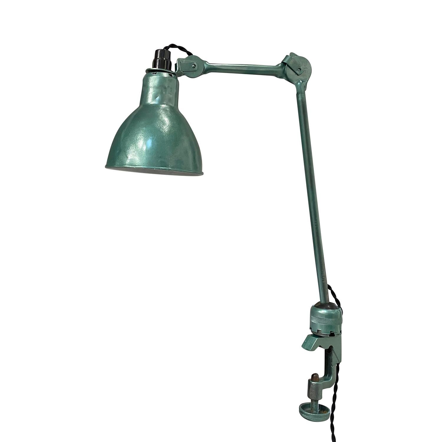 A light-green, vintage Art Deco French office, work light made of hand crafted metal, in good condition. The late industrial table, desk lamp is composed with two adjustable arms, featuring a one light socket. The wires have been renewed. Wear