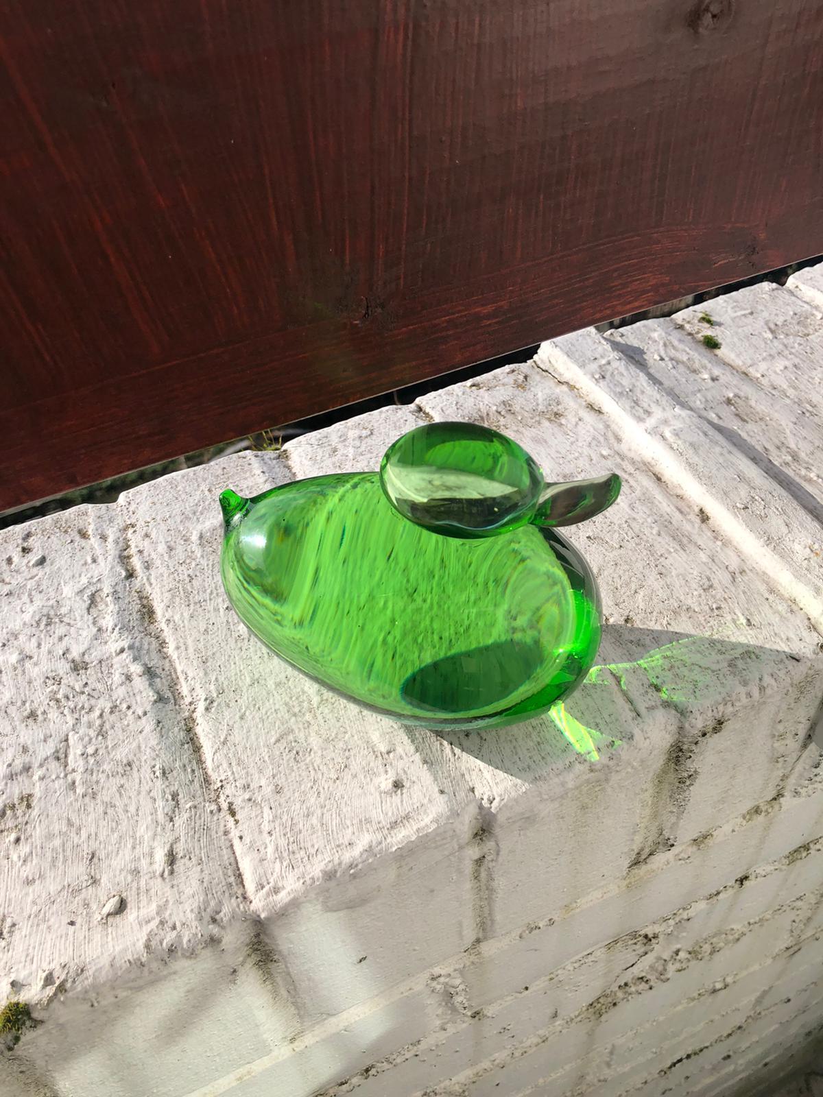 A heavy midcentury green colored glass duck-shaped paperweight.