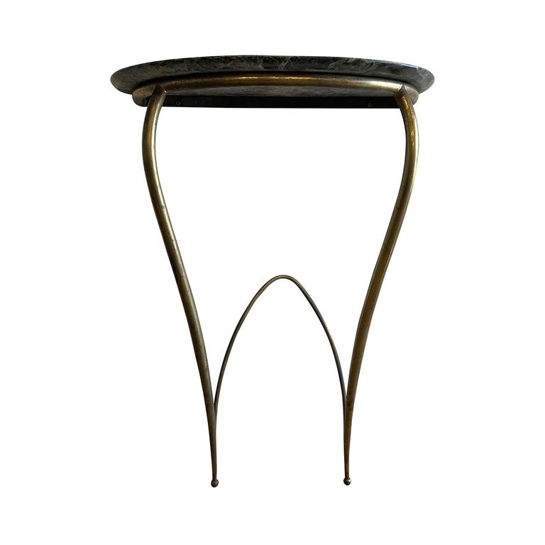 A half round, vintage Mid-Century modern Italian pair of wall mounted console tables made of hand crafted metal, brass with a green Belgian marble top, in good condition. The demi-lune end, side tables are standing on two sculptural legs, designed