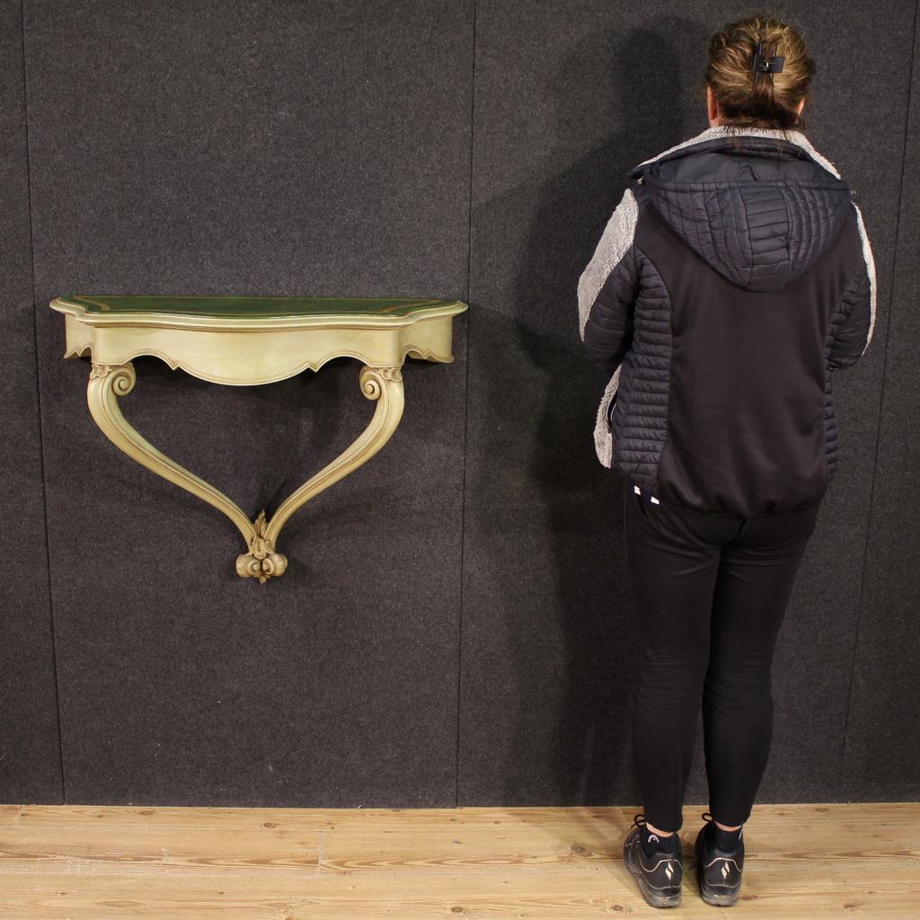 Italian console from the second half of the 20th century. Furniture in carved, lacquered and painted faux marble wood of excellent quality. Console to be fixed to the wall thanks to two special rear hooks (see photo), to be anchored to the wall for