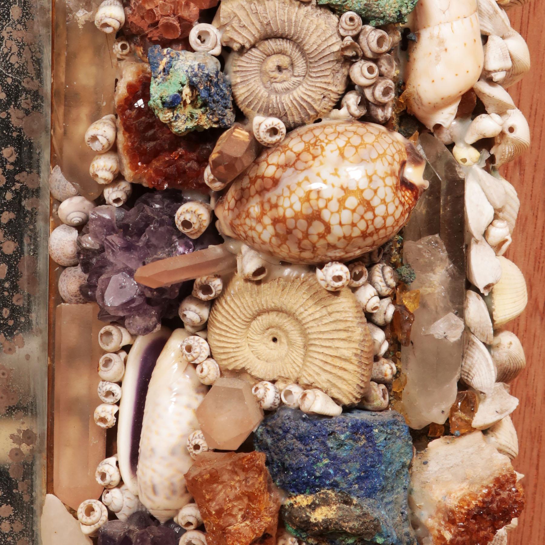 A fabulous 20th century Grotto style wall mirror, the frame profusely decorated with shells, corals, stones and polished agate.

Italy, circa 1900

Measures: Height 117 x 79cm.