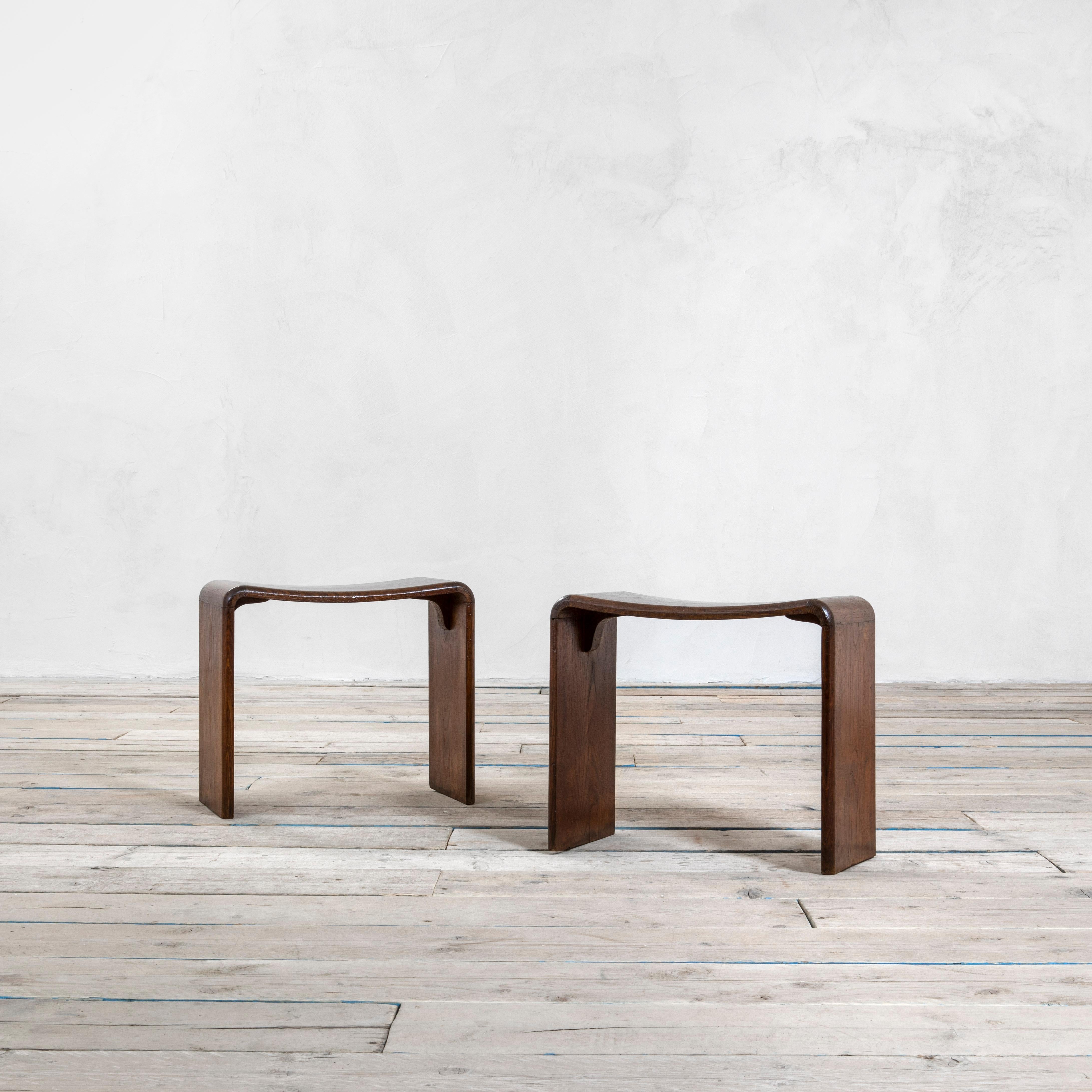 Set of two Stools in the style of Guglielmo Ulrich designed in '50s. They could be meant also as feetstools or general seatings. The two seats are completely in wood and have a special curved shape. 
Good condition, patina of time.
 