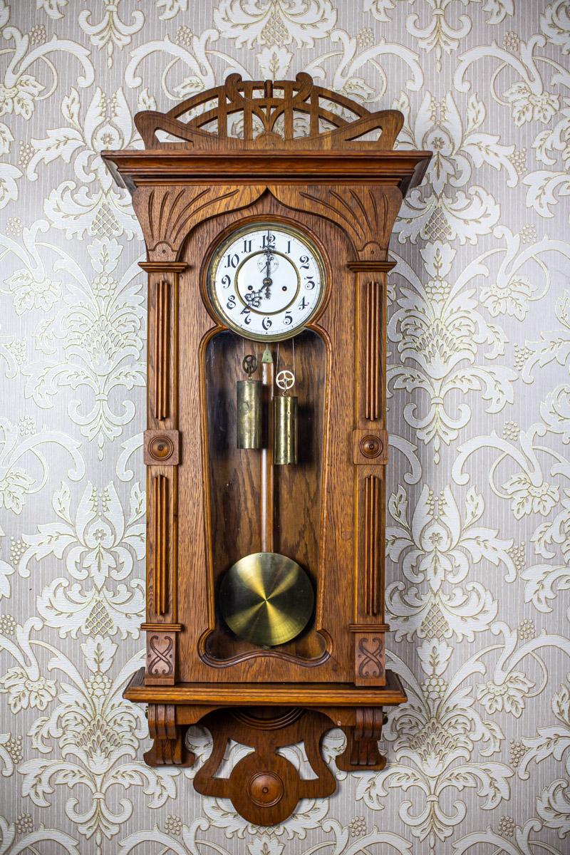 We present you a wall clock from the early 20th century with weight acceleration.
The mechanism was made by the famous German company of Gustav Becker.
(The signature is placed on both the mechanism and pendulum.)
Furthermore, the walls of the