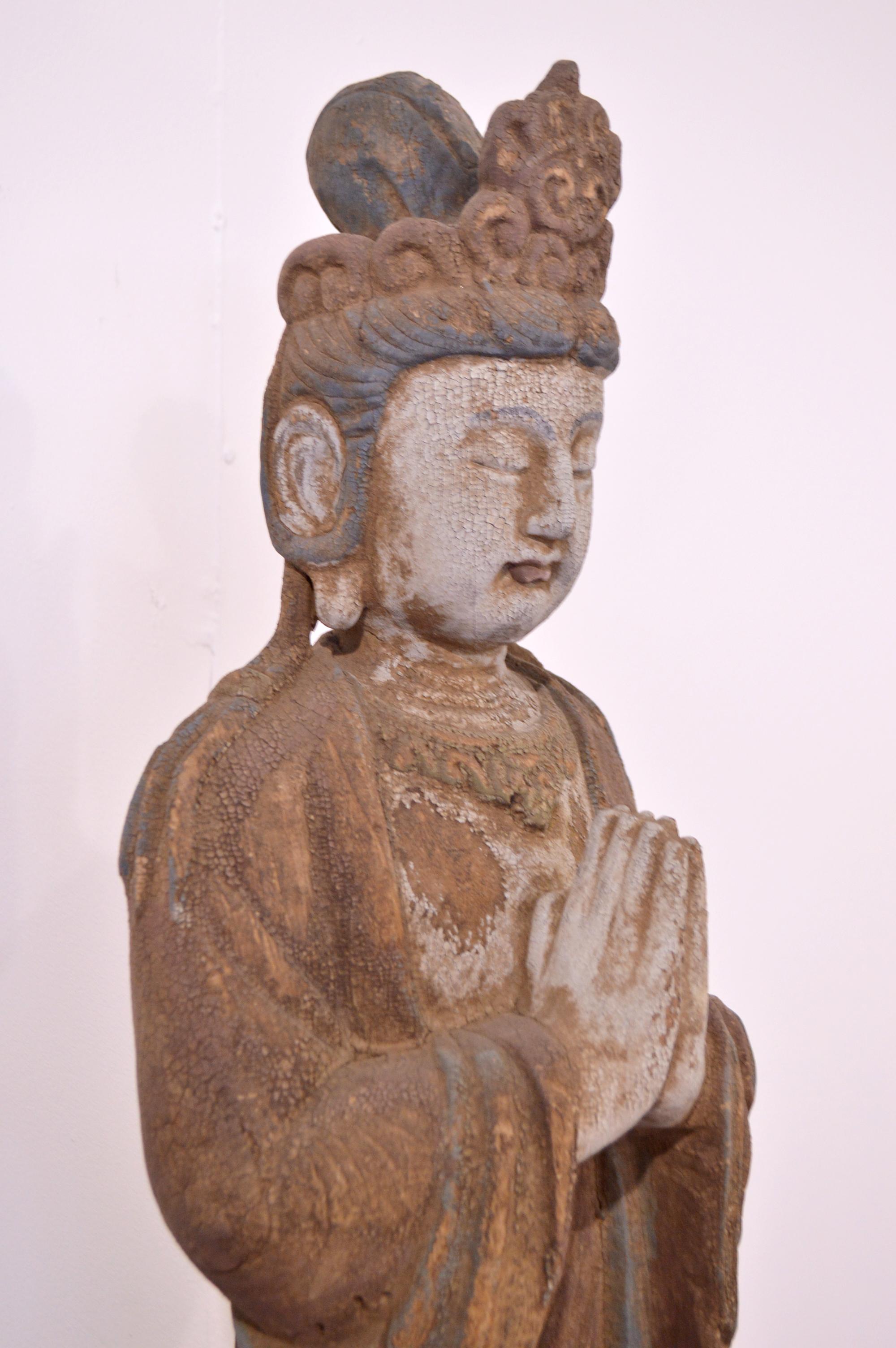 carved wood standing buddha