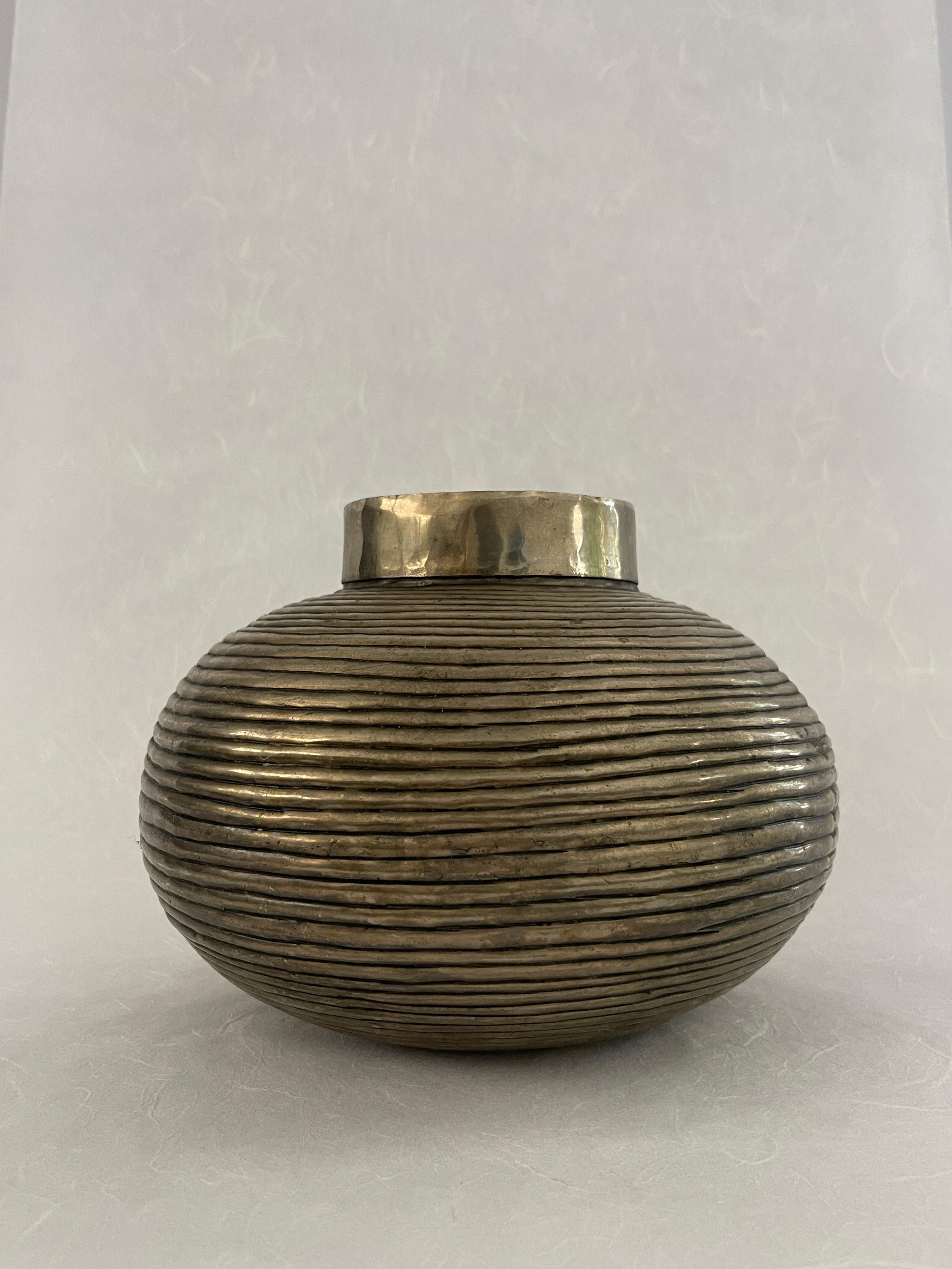 20th Century Hand Crafted Brass Vase with a spherical ribbed body and a cylinder top opening. Unique hand crafted imperfect welded finish between the riblets to give it that brutalist hand done look. 