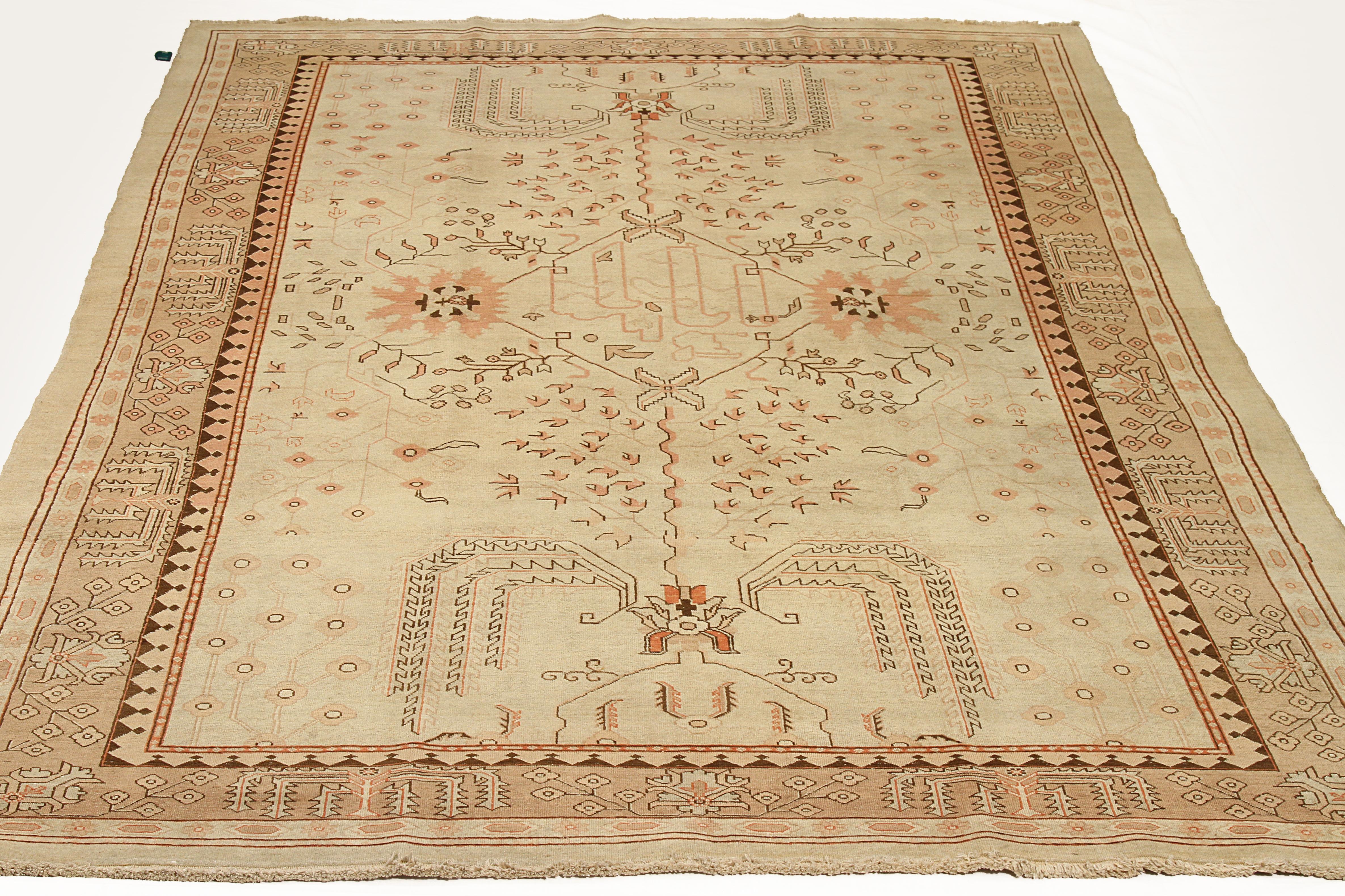 Mid-20th century hand knotted Persian area rug made from fine wool and all-natural vegetable dyes that are safe for people and pets. This beautiful piece features botanical and floral patterns set in an ivory field which is a hallmark of a Haji