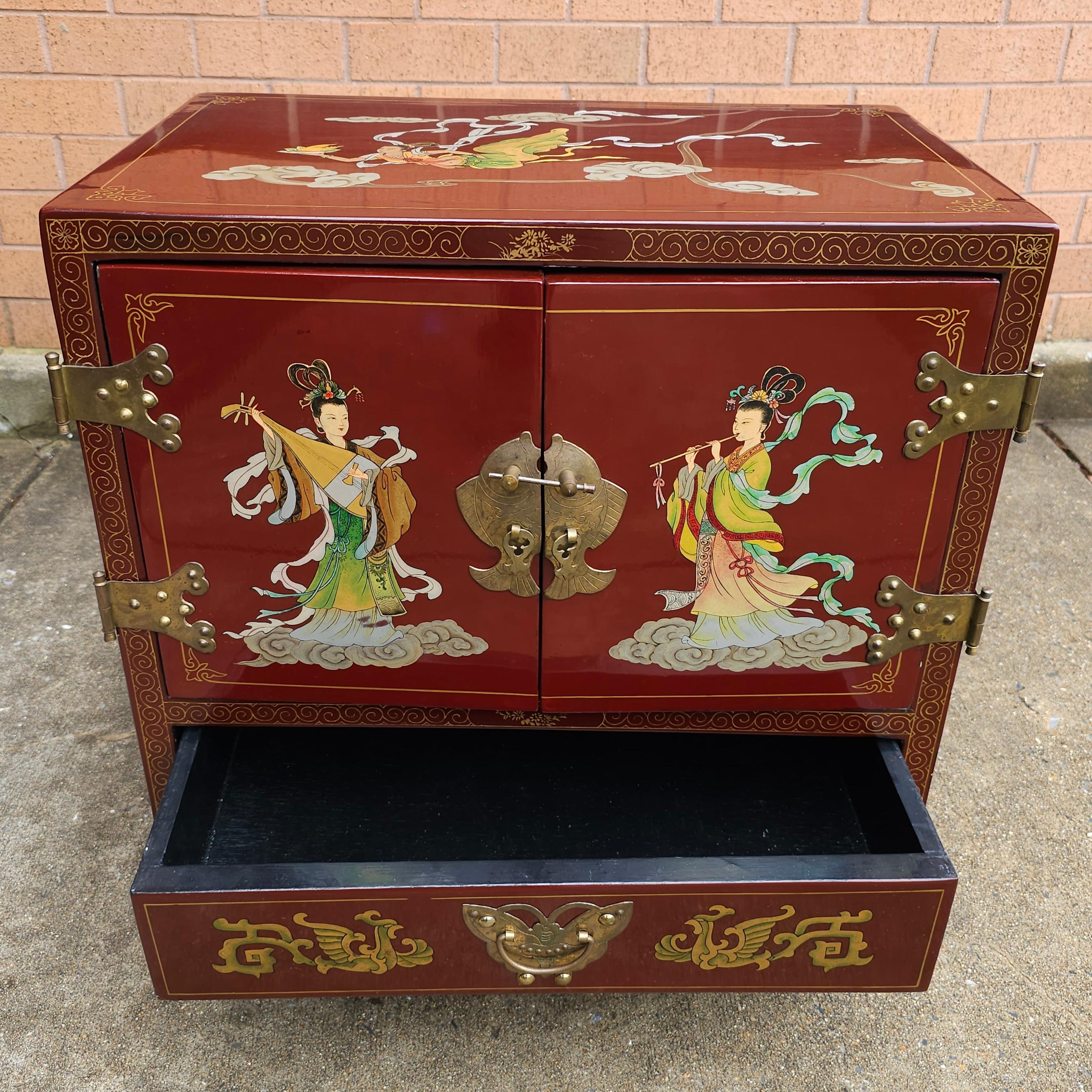 A 20th Century Hand Painted and Decorated Chinoiserie Red Lacquered Side Cabinet. Great vintage condition. 