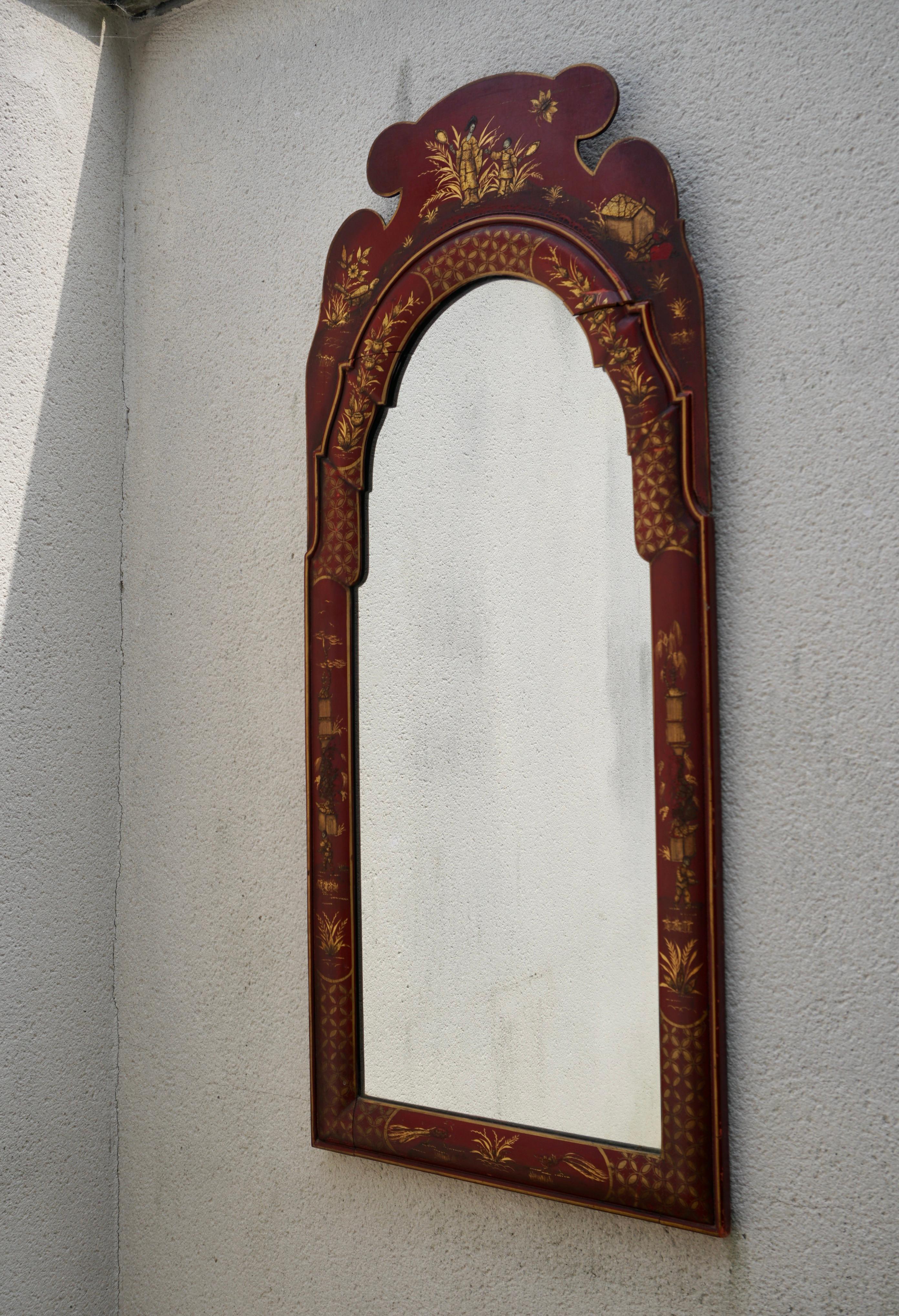 This is a lovely hand painted chinoiserie mirror with Georgian styling. It depicts hand painted pastoral scenes on a Chinese red background. The frame is wood and unmarked. It is believed to be Italian.