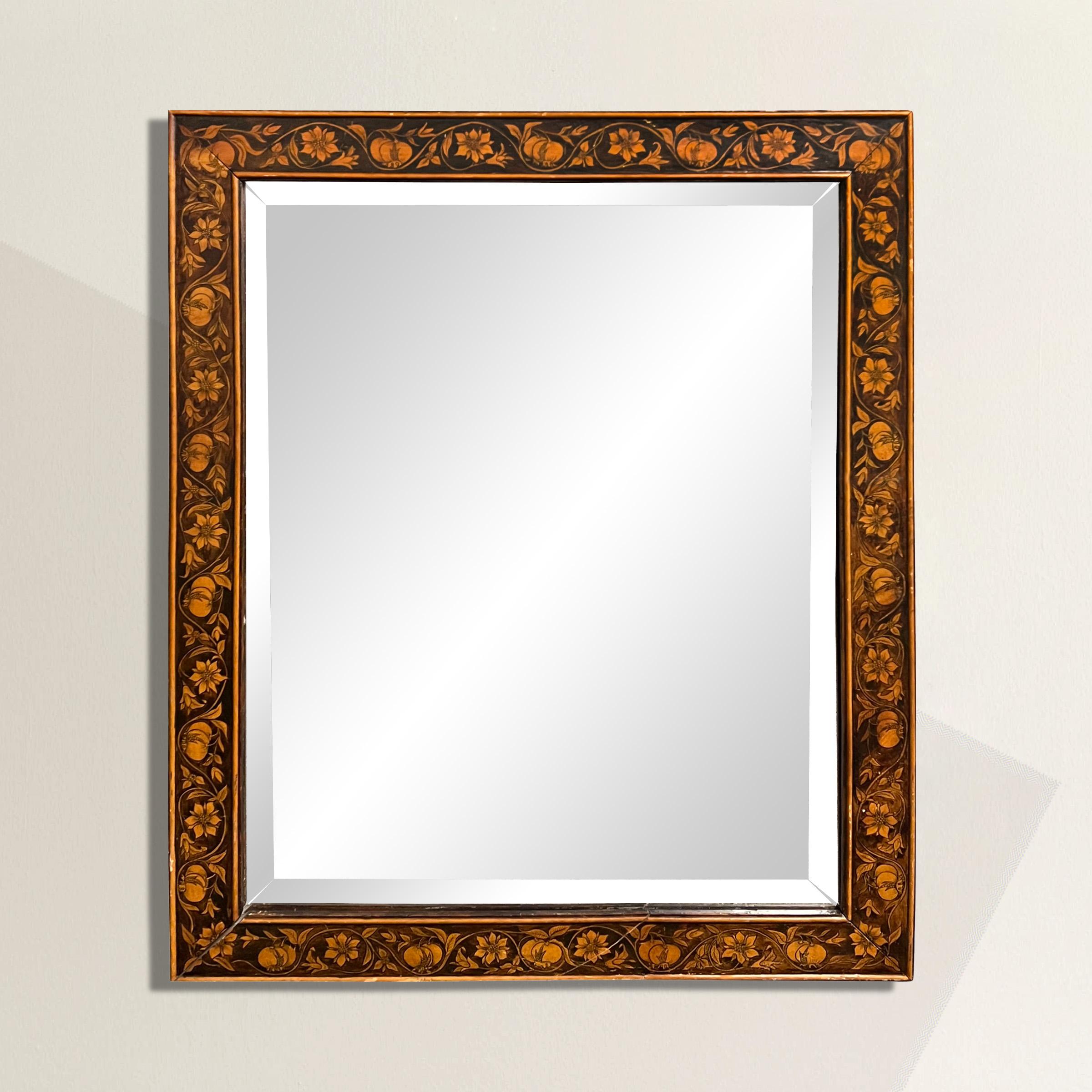 This exquisite 20th century framed mirror is a true masterpiece, adorned with delicately painted scrolling vines with pomegranate flowers and fruits that gracefully cover the face of the frame. The intricate detailing and craftsmanship captivate the