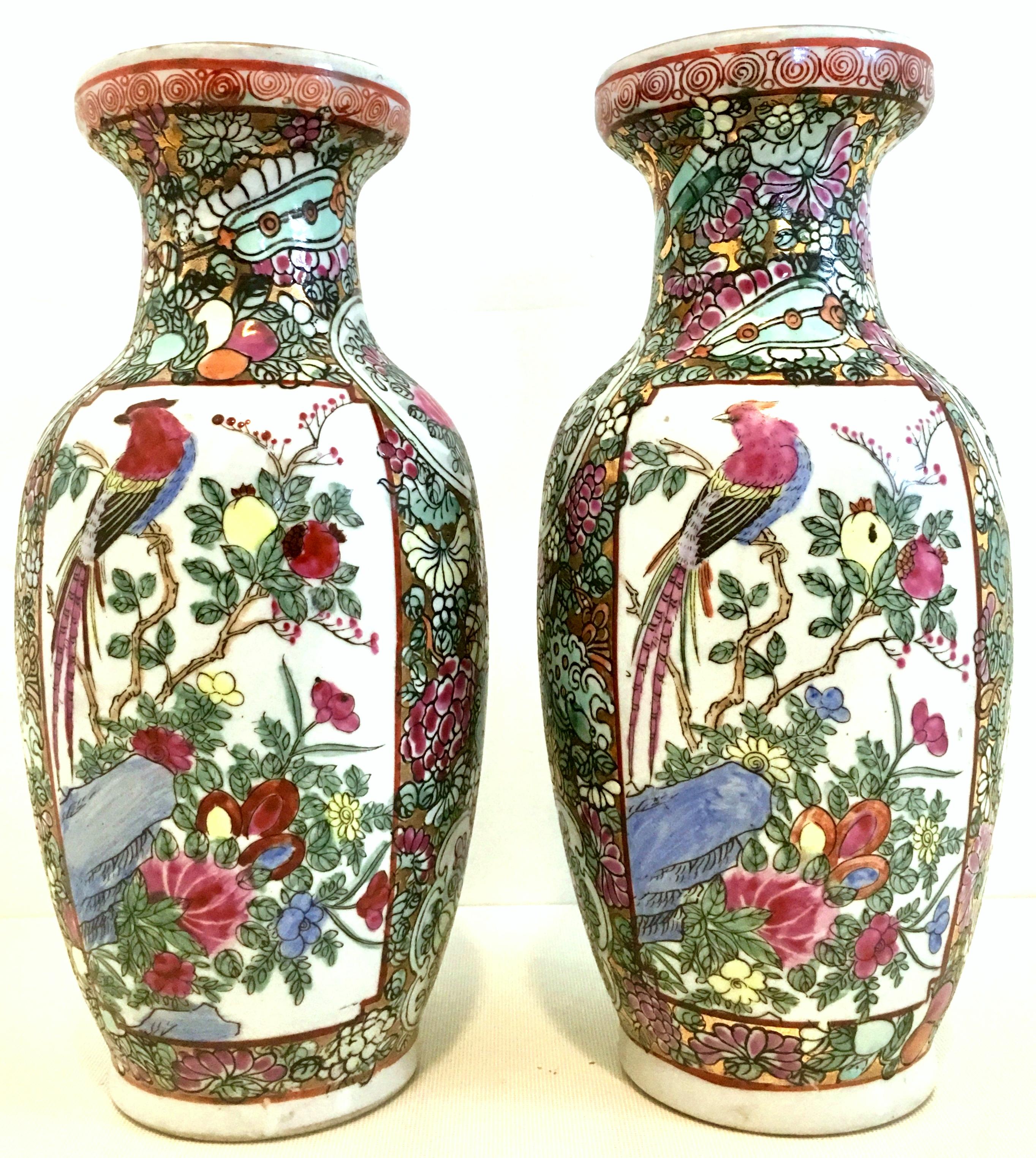 20th century Chinese Export porcelain hand painted famille rose pair of vases-Signed-Qianlong chop mark on each vase. These hand made, hand painted pair of porcelain and 22K gold detail vases depict double sided and opposite motif panel of birds on