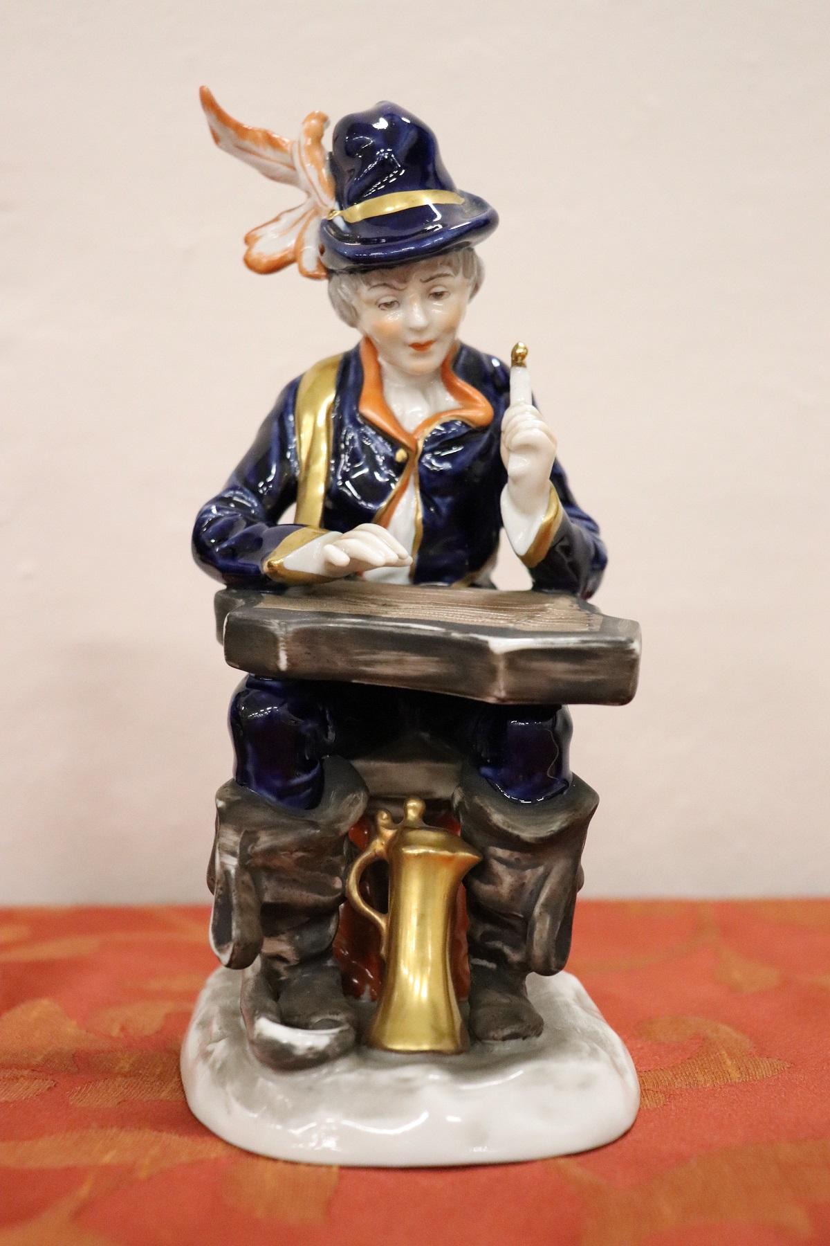 Refined hand painted sculpture in porcelain mark at the base. Two young players made with care in the details painted with clothes in shades of blue. Beautiful collectible porcelain.