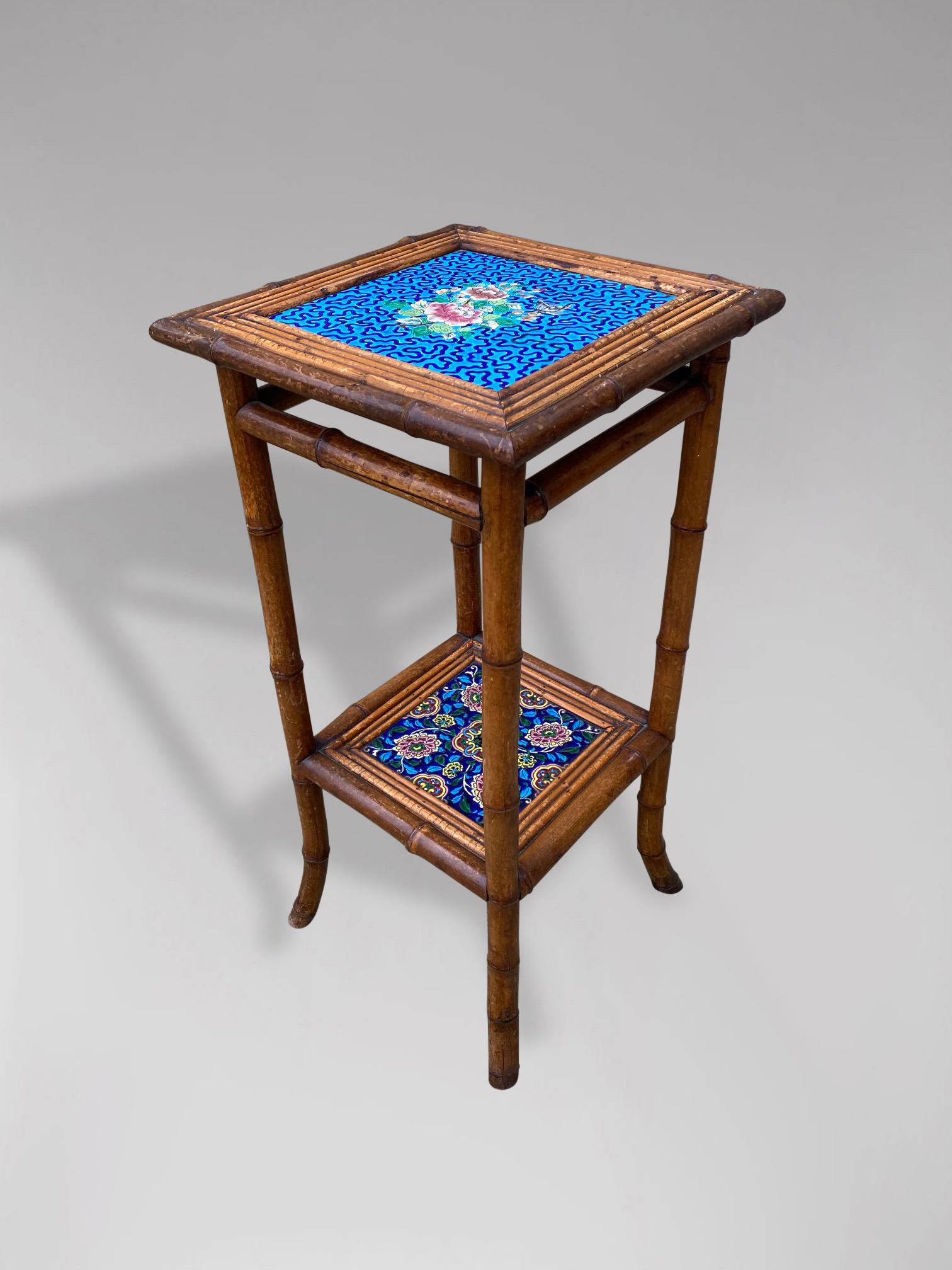 A wonderful antique tiled top bamboo side table or plant stand. A square two tier bamboo side table in excellent condition with antique hand painted ceramic tile inserts on top and bottom shelf units in bright blue colour tones. Circa 1900. Great