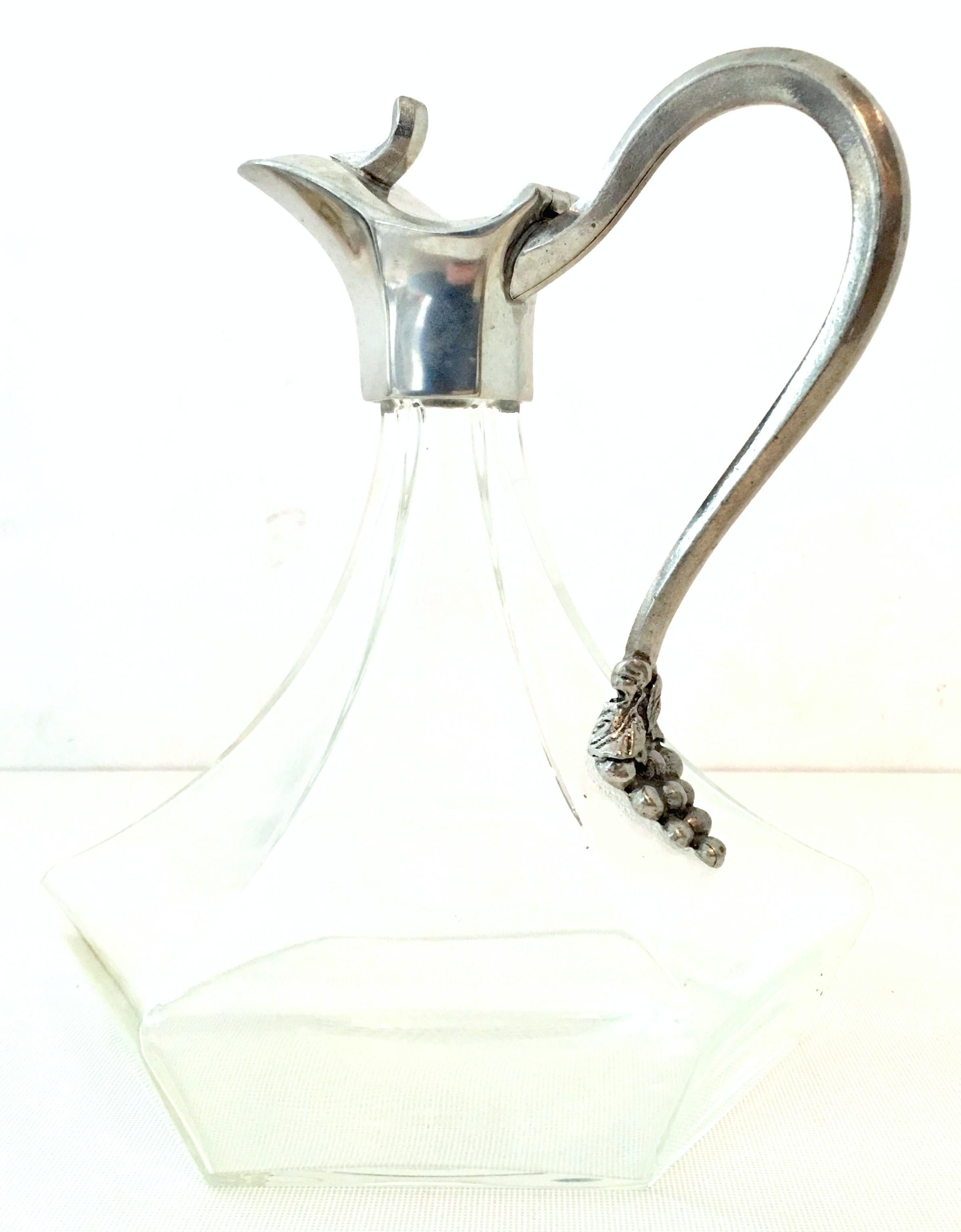 20th century French handmade blown glass and pewter grape motif hinged carafe pitcher. This lovely handcrafted piece is signed on the underside of the hinged top,
Etian Fait Main-Jean Goardere.