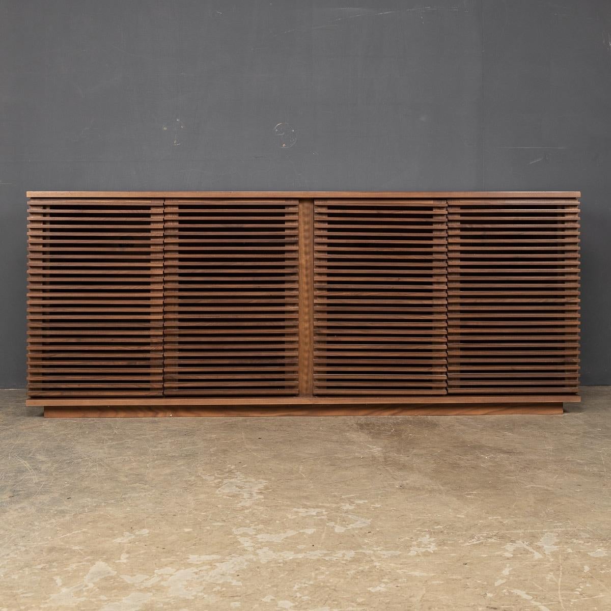 Late 20th Century walnut sideboard created exclusively for Heals by award winning designer Nathan Yong. This striking Credenza is part of a range called “Linea” in the late 20th Century. A sleek design with four opening doors revealing two cupboards