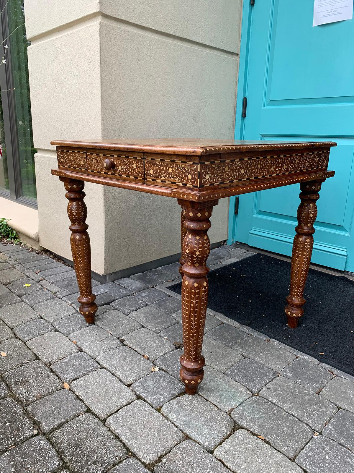 20th century circa 1970s Anglo-Syrian or Anglo- Indian heavily inlaid teak and satinwood square game table, checkerboard top, two drawers, turned legs.