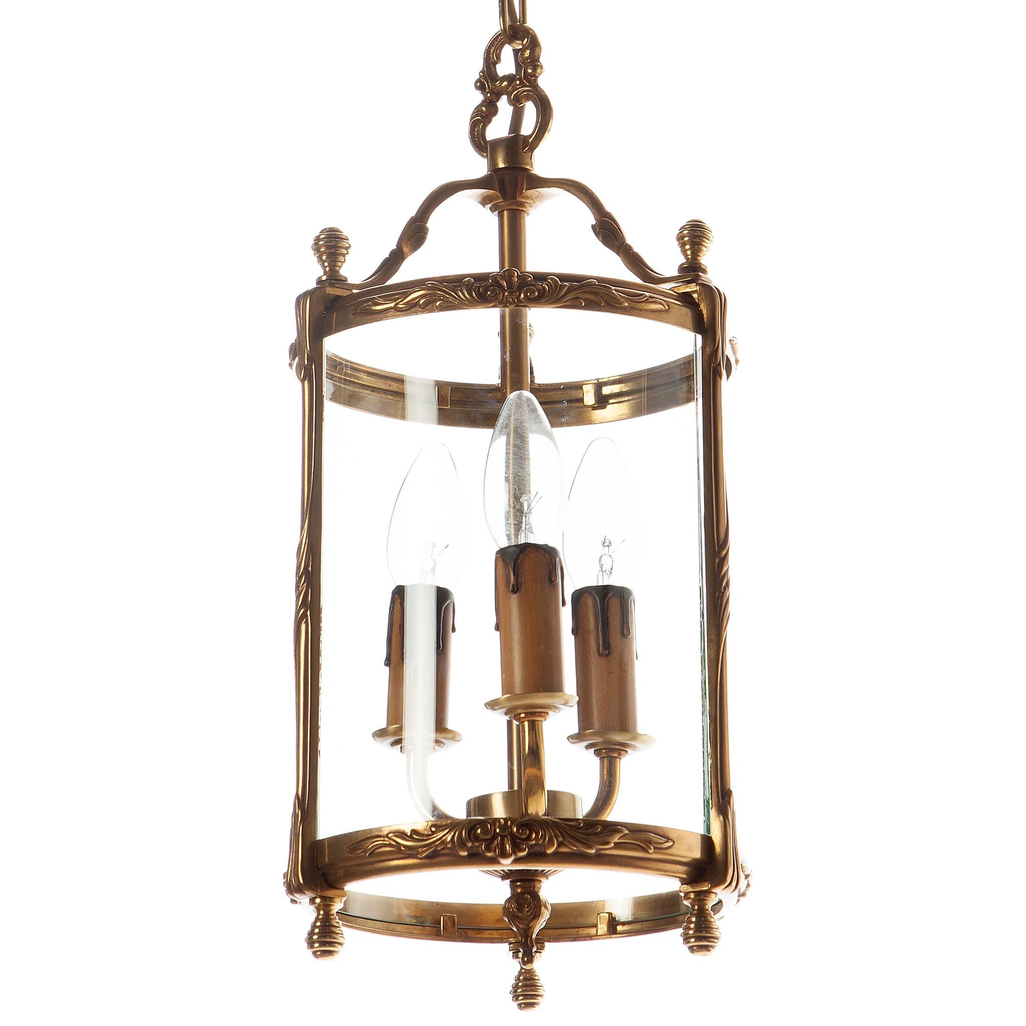 A neoclassical hall lantern of great design. A heavy cast brass base surrounded by four sectional circular convex glass panels.