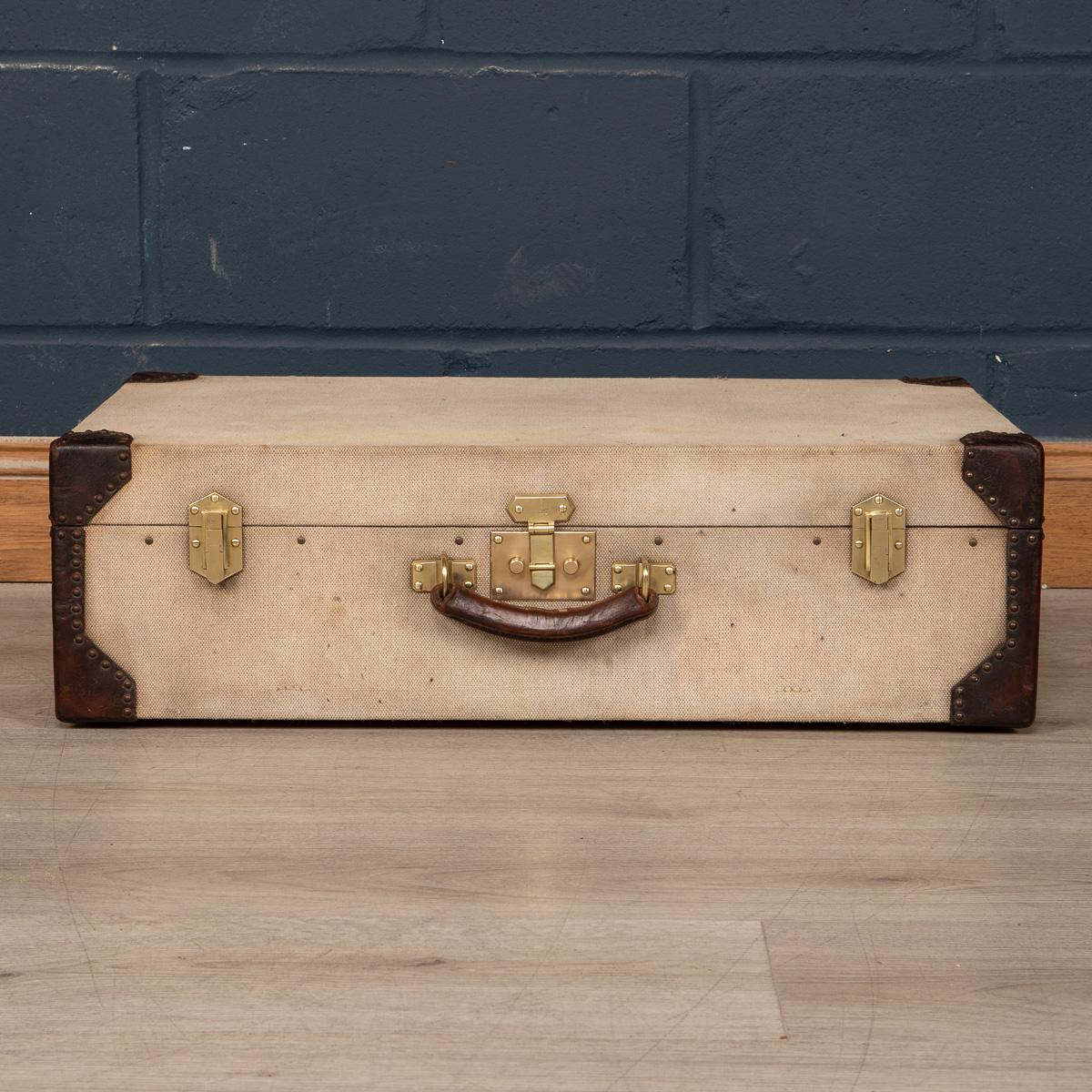 A very rare Hermes suitcase in canvas covering, leather reinforced edging with brass locks and side latches, made in France in the early part of the 20th century. A great addition to any collection and a fantastic item to have as part of a stack in