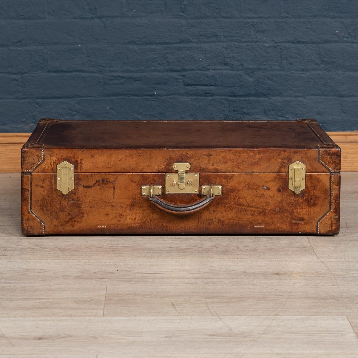 A very rare Hermès suitcase in natural cow hide covering and brass locks and side latches, made in France at the beginning of the 20th century. A great addition to any collection and a fantastic item to have as part of a stack in any interior
