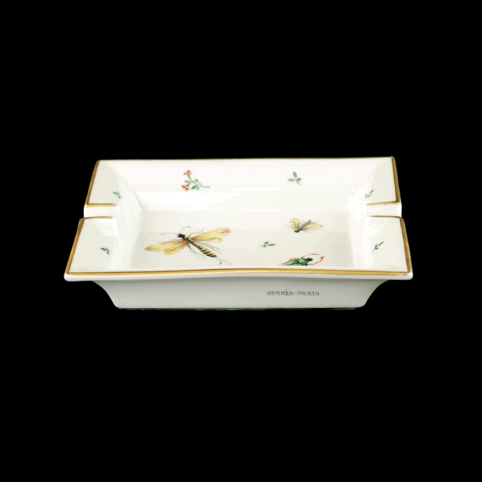 This vintage porcelain 2 rest ashtray was made for renowned French luxury goods purveyor Hermès. The iconic institution has been a fixture of the Parisian fashion scene since its founding in 1837. The ashtray has a rectangular shape with canted