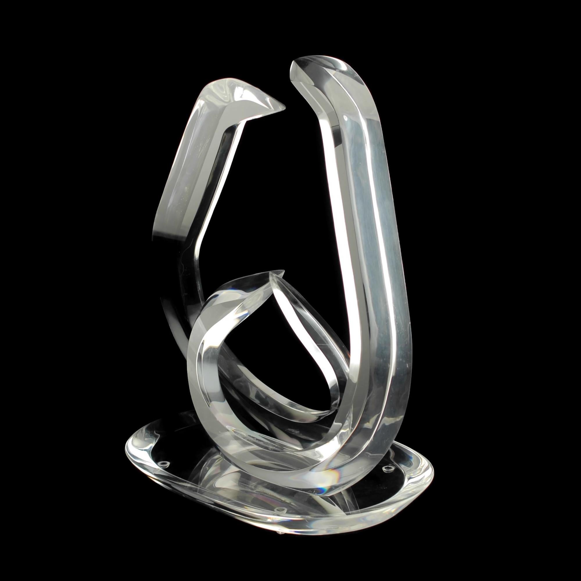 This modernist Hivo Van teal clear Lucite sculpture features two thick four-sided curved arm-like forms which terminate in sharp points. The arms are approximate mirror images of each other and are positioned side by side with their bodies angled