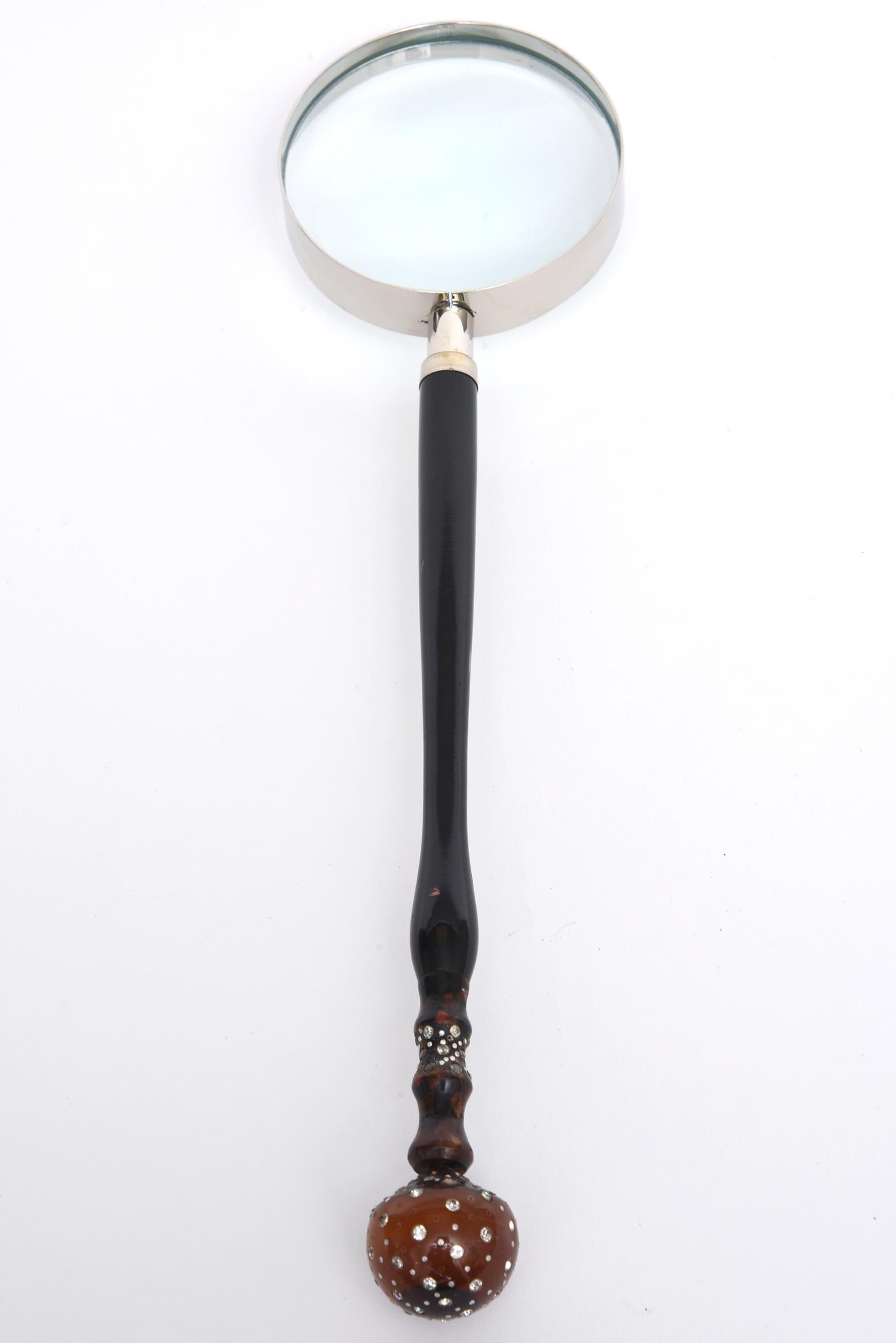 Magnifier with round Bakelite ball accent encrusted with rhinestones, connected to a long ebony handle. The chrome magnifier is a later addition to the vintage handle.