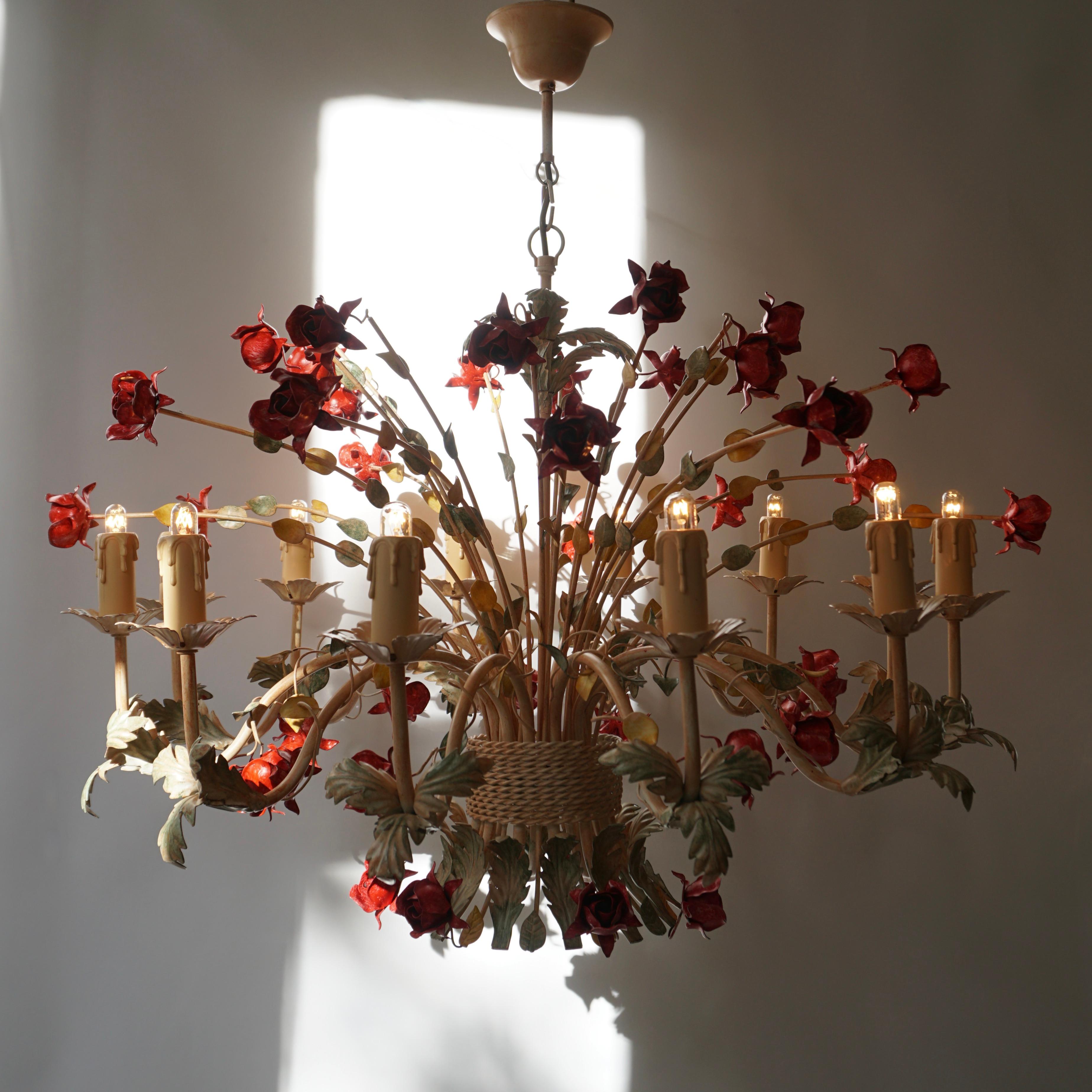 Two stunning 20th century Hollywood Regency style chandelier with red roses.

This ornate and exuberant Italian chandelier is adorned with a plethora of beautiful red roses.The ornate detail and delicate flowers give this wonderful chandelier a