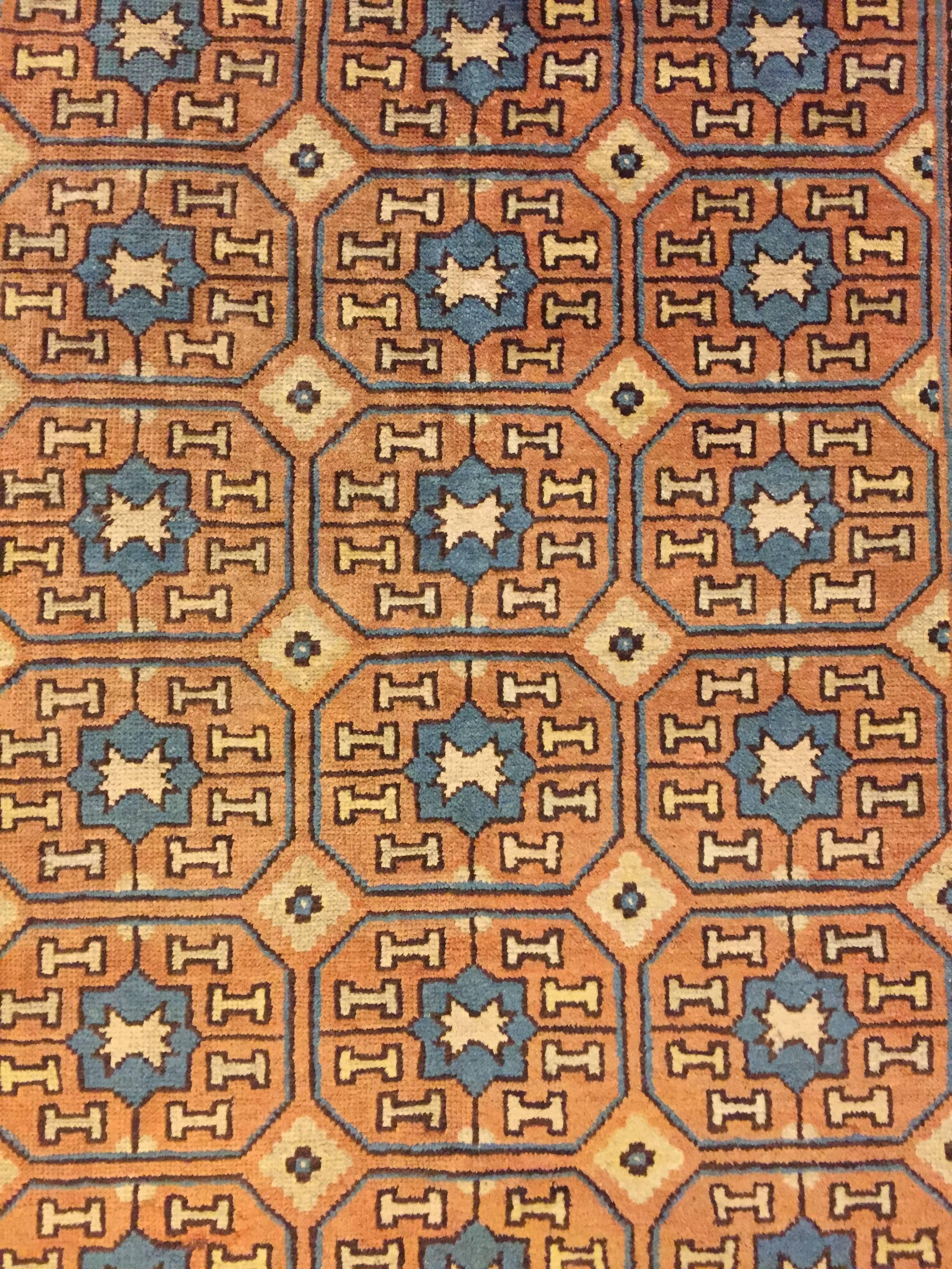 Hand-Knotted 19th Century Brown and Blue Stylized Rosette Gul Chinese Khotan Rug, circa 1870s For Sale
