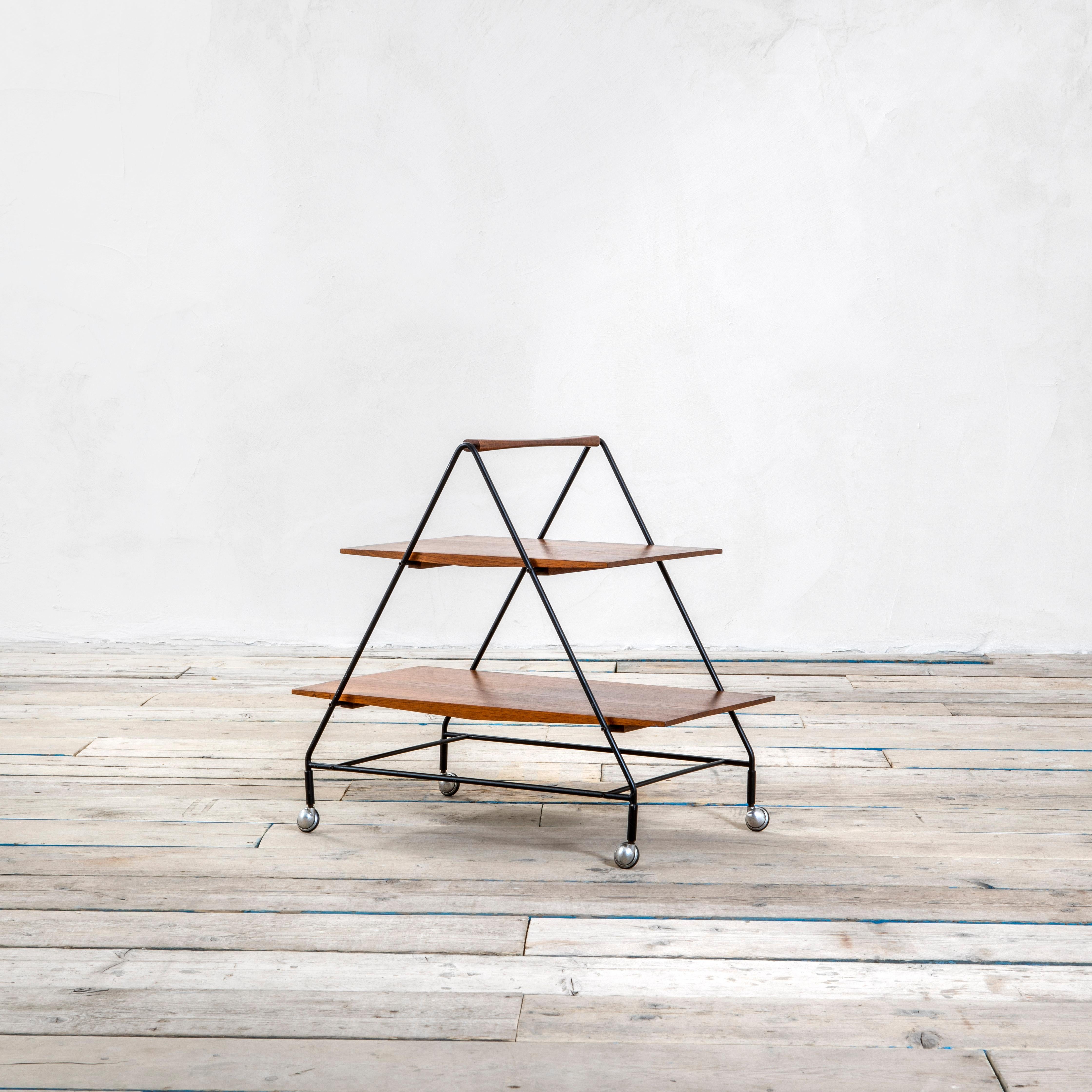 Bar cart designed in '60s by Ico Parisi for MIM Mobili Italiani Moderni. The Bar Cart has a lacquered metal structure with 2 trays in wood, the cart can be easily moved thanks to four wheels. On a tray there is the original brandmark MIM.
It can be