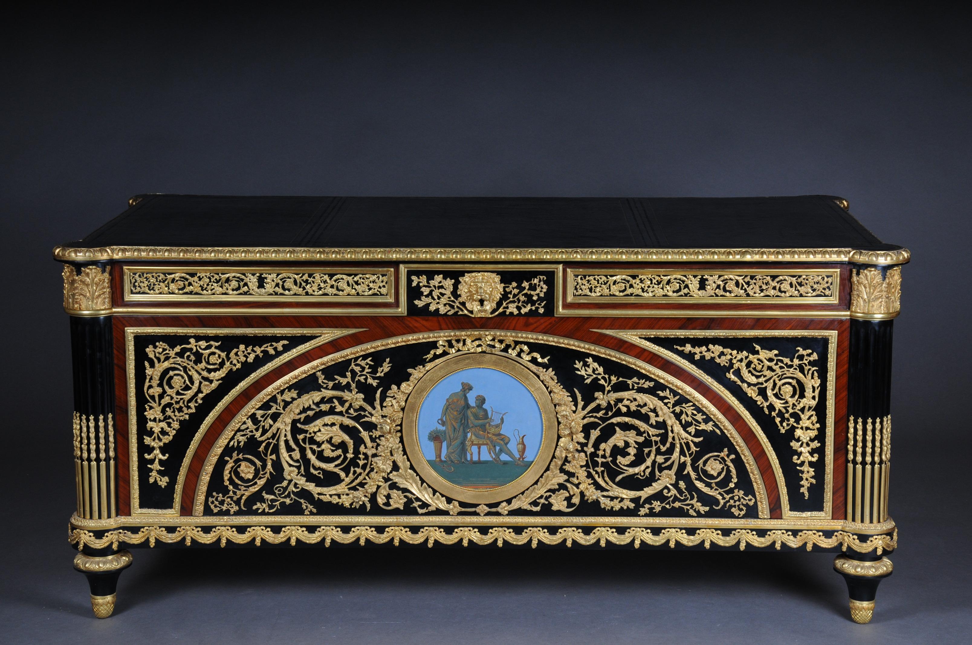 Imperial bureau plat / desk in the style of Louis XVI

Piano black polished veneer on solid oak and wood. Extremely finely chased and rich bronze applications. Rectangular body. A hand painted picture badge on the front and side view. Gilded