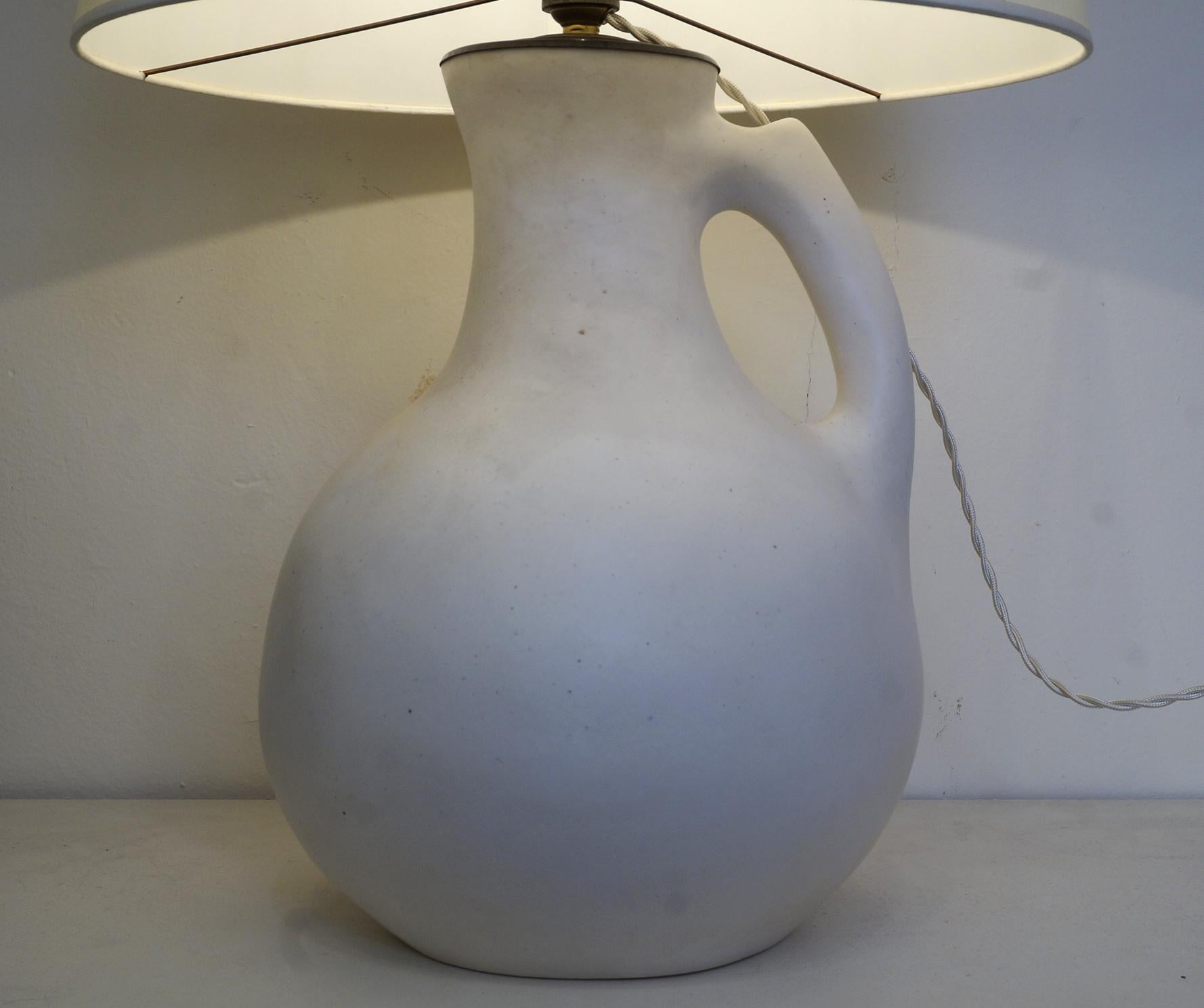 White enameled ceramic table lamp, custom made fabric lampshade,
 rewired with twisted silk cord.

Measures: Ceramic body height 34 cm – 13.4 in.
Height with lampshade 60 cm - 23.6 in.