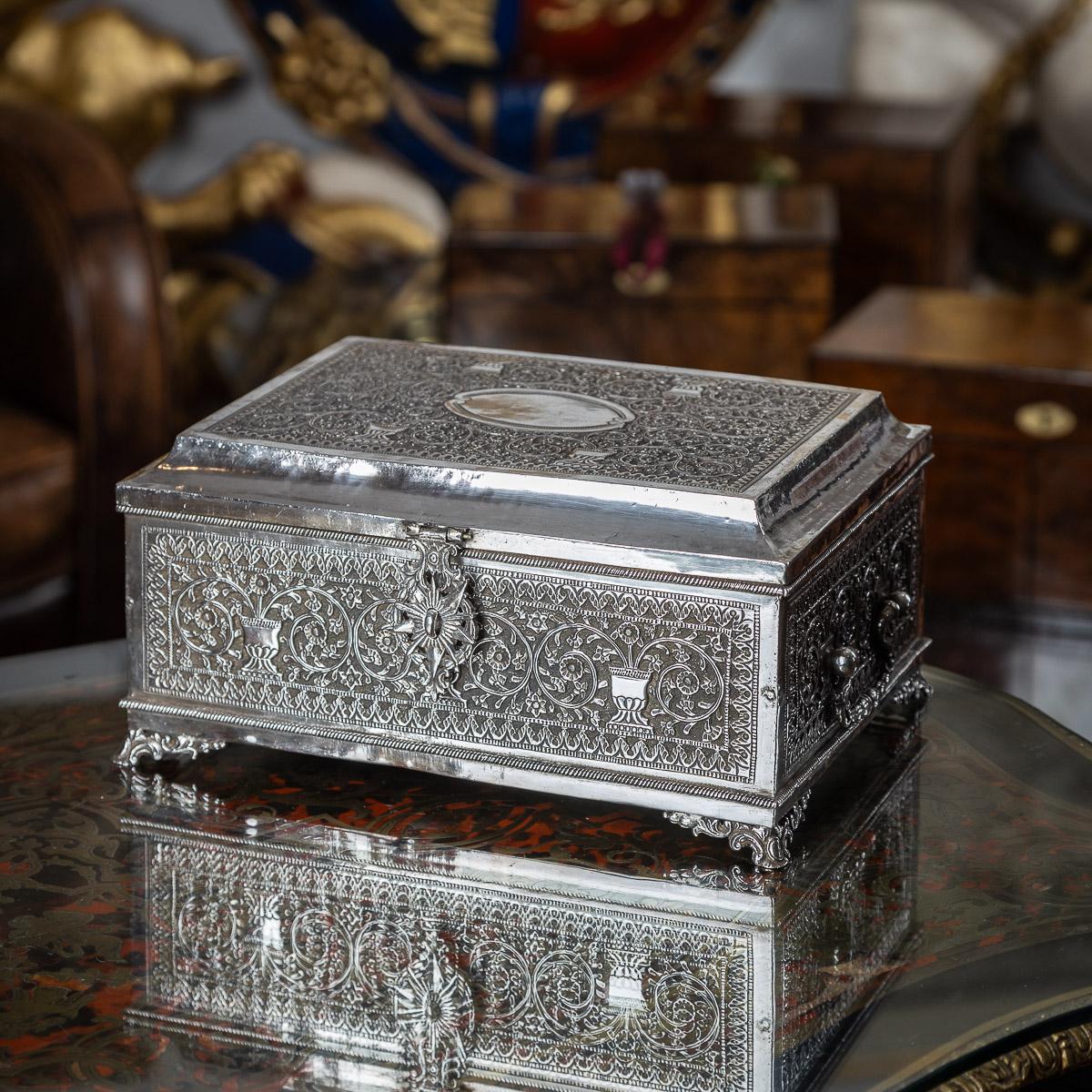 Antique early 20th Century Indian Kutch (Cutch) very rare solid silver jewellery casket, It embodies the traditional form with impressive weight and exquisite craftsmanship. The casket stands on four floral scroll feet, showcasing a large hinged