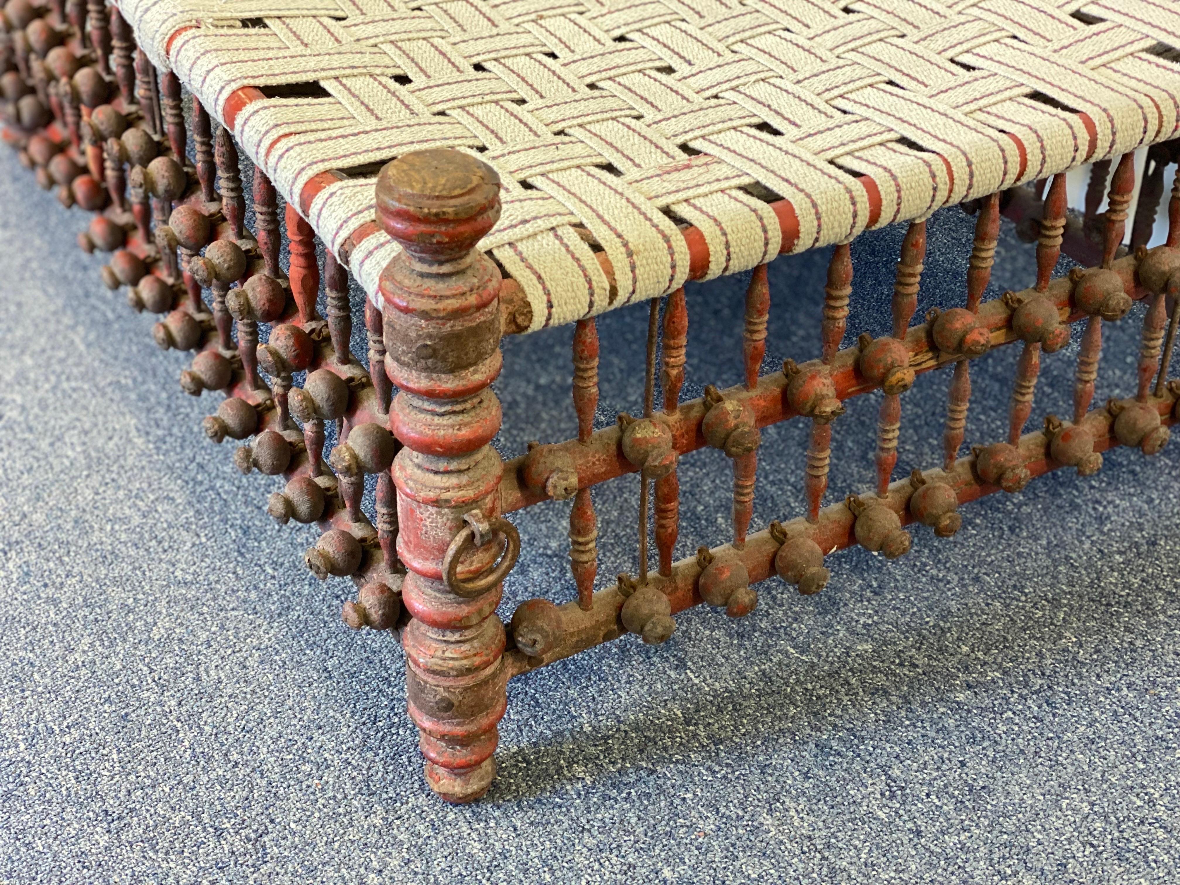 20th Century Indian Red Painted Wooden Ball & Stick Ottoman For Sale 1