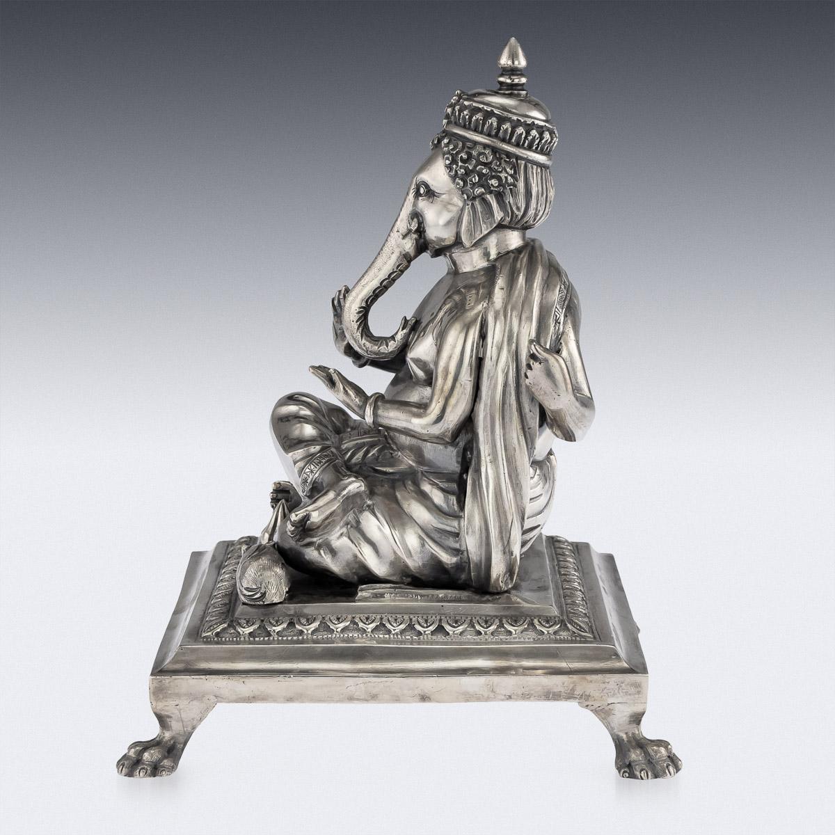 Antique 20th century Indian very rare solid silver statue of Ganesh Chaturthi (Vinayaka Chaturthi), seated on a leaf chased plinth supported by four cast lion paw feet, the statue is well cast, heavy gauge and detailed, Ganesh seated in his