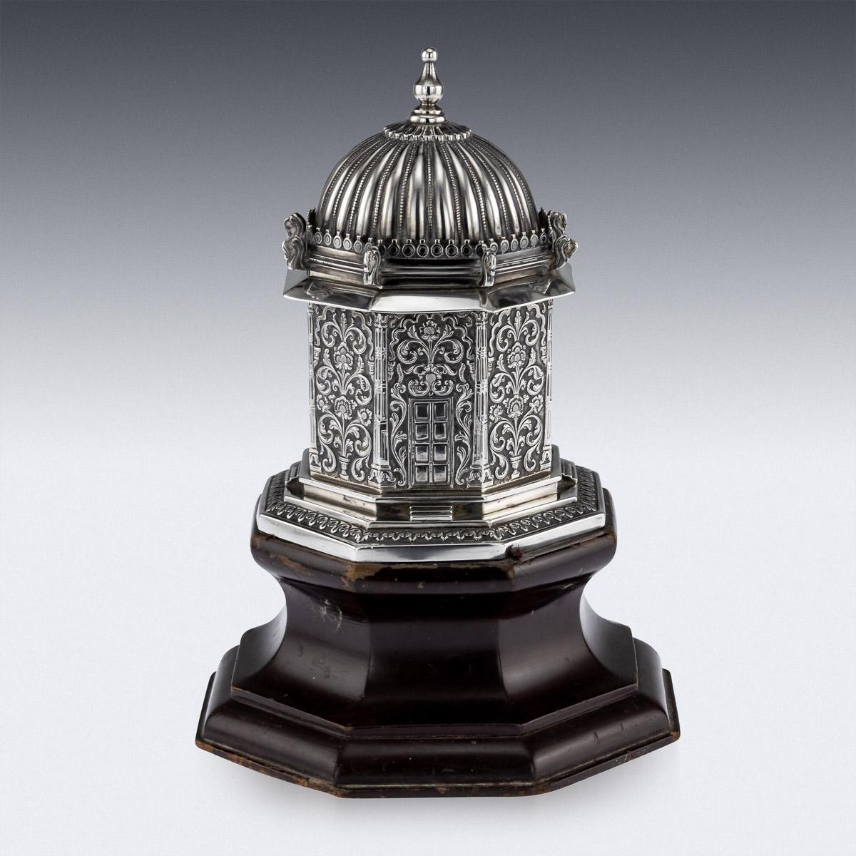Antique early 20th century exceptionally rare Indian Colonial solid silver tea caddy on stand shaped as a small Hindu courtyard temple. Of octagonal form on a stepped foot, highly chased and embossed, decorated with floral sprays and scrolling vine