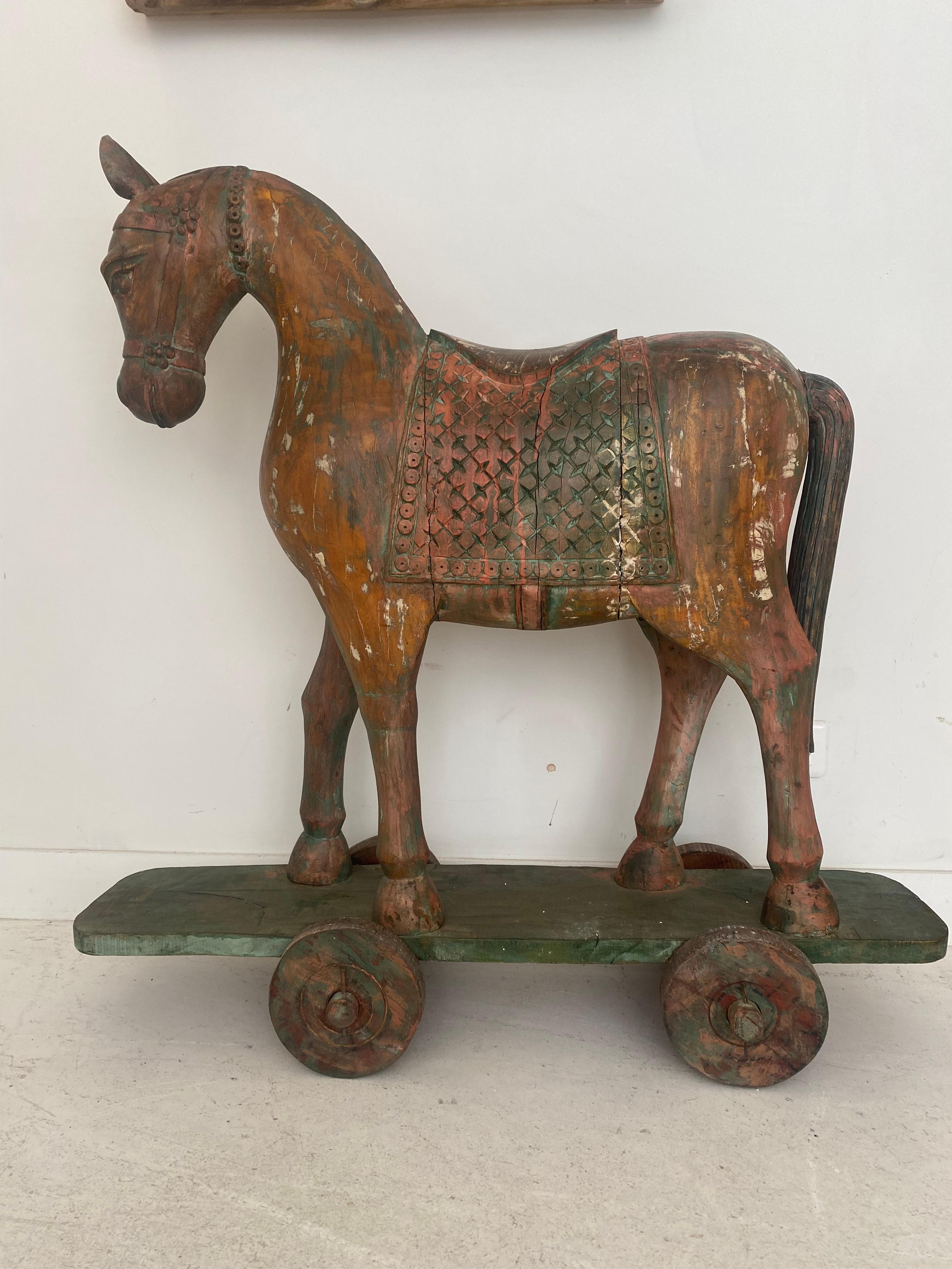 Oversized 20th century wooden Indian temple horse, hand carved and decorated in polychrome, sitting atop a skateboard. Very fine craftsmanship, imposing temple horse sculpture.
Arts and crafts, folk art Decorative ceremonial horse.
Anglo Raj toys