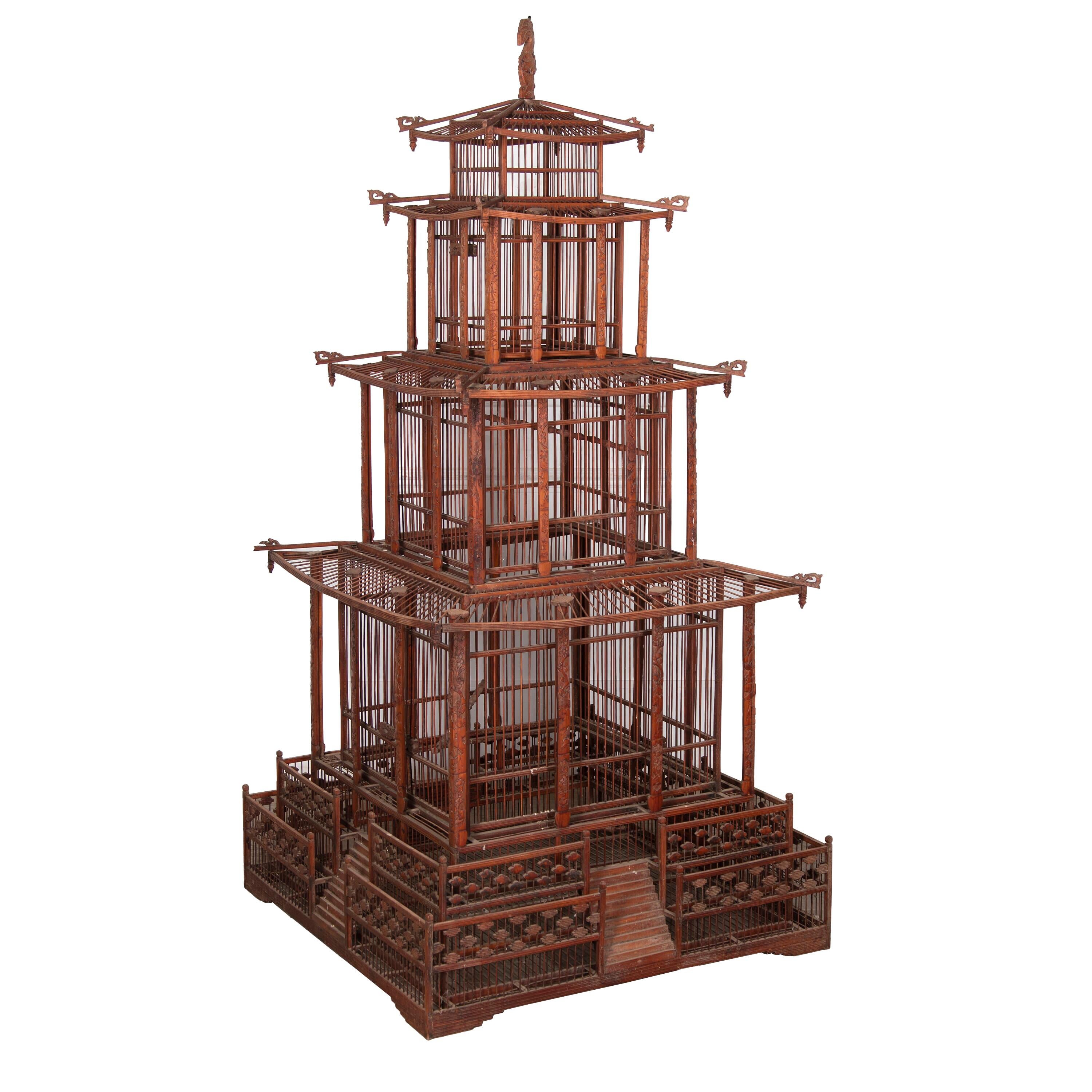 Exceptional 20th Century bird cage in ironwork and wood.
This bird cage was bought back at the beginning of the 20th Century from Indochina by the grandfather of the former owner to house exotic birds.
This example is rare due to its outsized