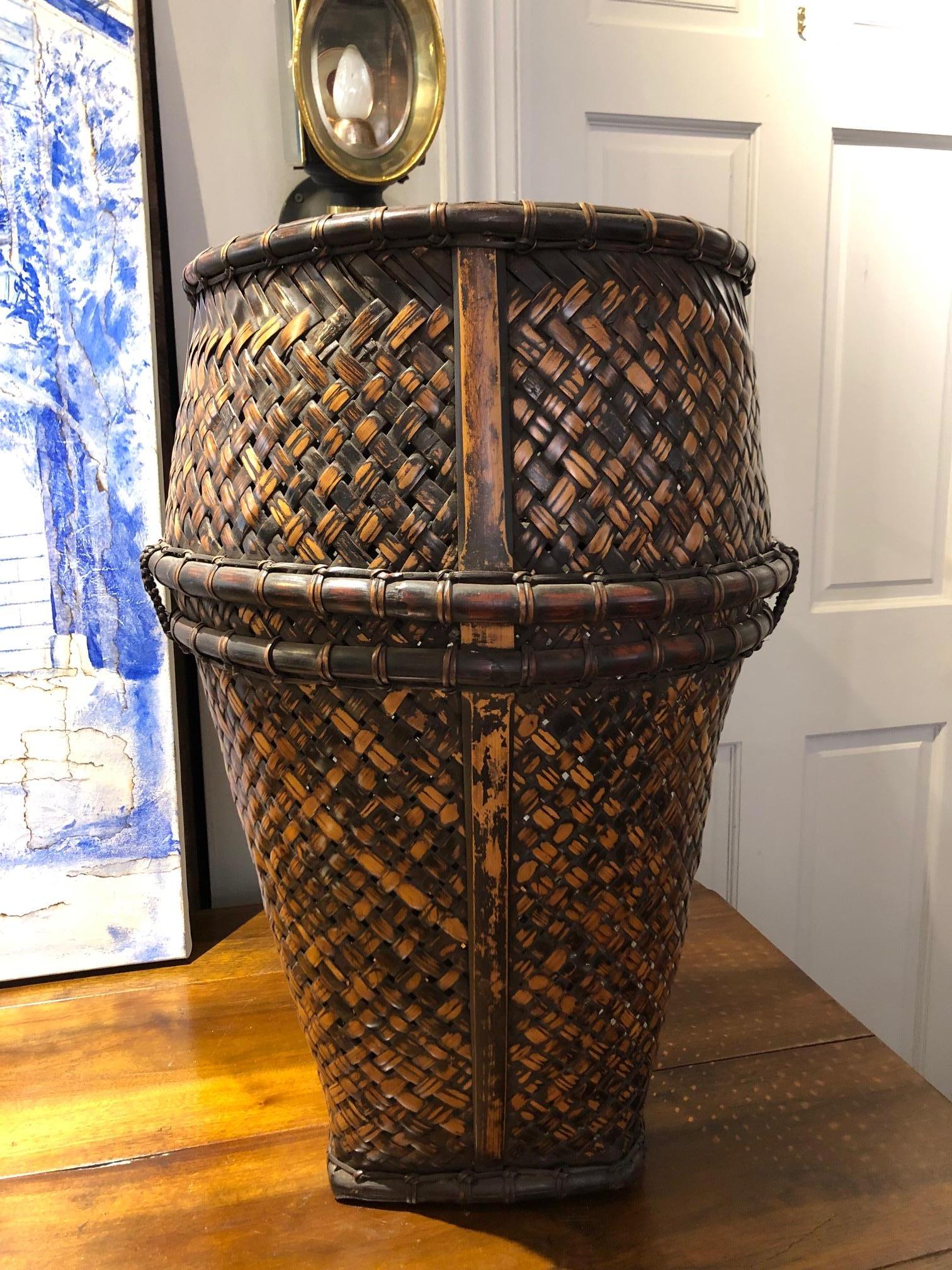 Beautiful handwoven Indonesian hauling basket made from rattan and bamboo with a remarkable deep color and patina. This Agrarian art makes for a beautiful display or storage piece in your home. 
Sulawesi, circa 1930.
Measures: 24