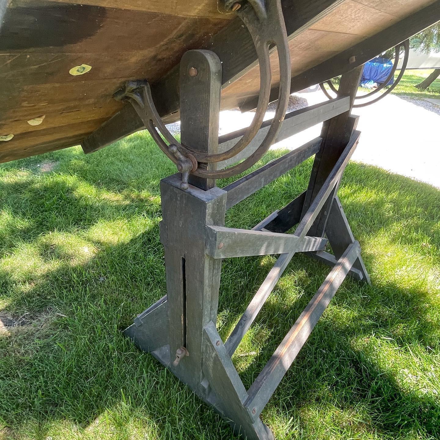 Vintage wood and cast iron Industrial drafting table with an adjustable height and a pivoting surface . Lovely patina on the table top and has that wonderful old world feel that would look great in any space . Marked with an Alvin label 
