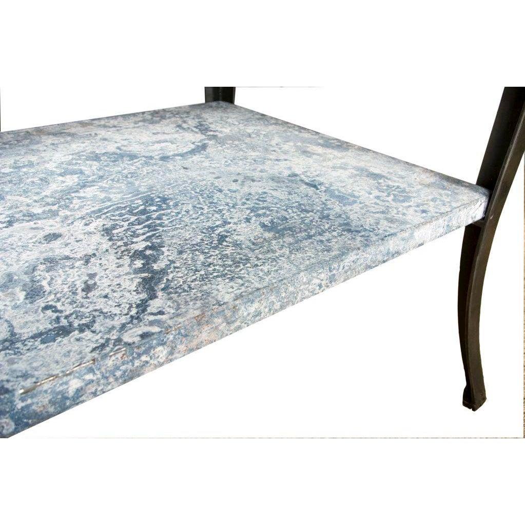 A unique industrial two-tier table featuring iron legs and an oxidized zinc table top. The oxidized zinc gives the table a uniquely beautiful touch, there are some areas of rust on the top. This can work great for entry center piece table, a kitchen