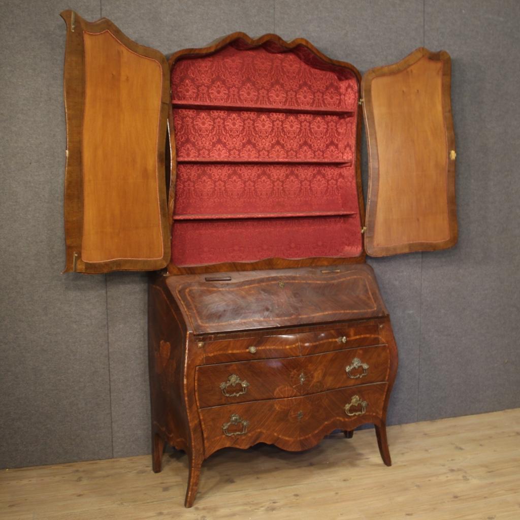 Italian trumeau from the first half of the 20th century. High quality cabinet, inlaid in palisander and rosewood, adorned with four-leaf clovers on the front and sides. Trumeau double body equipped with four external drawers, fall-front, two candle