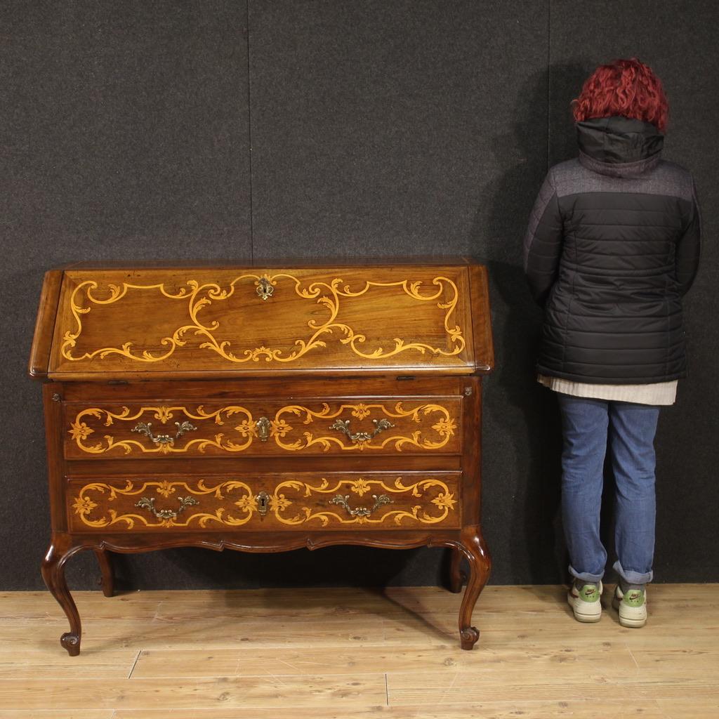 Italian bureau from the first half of the 20th century. Antique-style furniture carved and inlaid in walnut, maple and fruitwood of beautiful line and pleasant furnishings. Bureau equipped with two external drawers of good capacity plus fall-front.