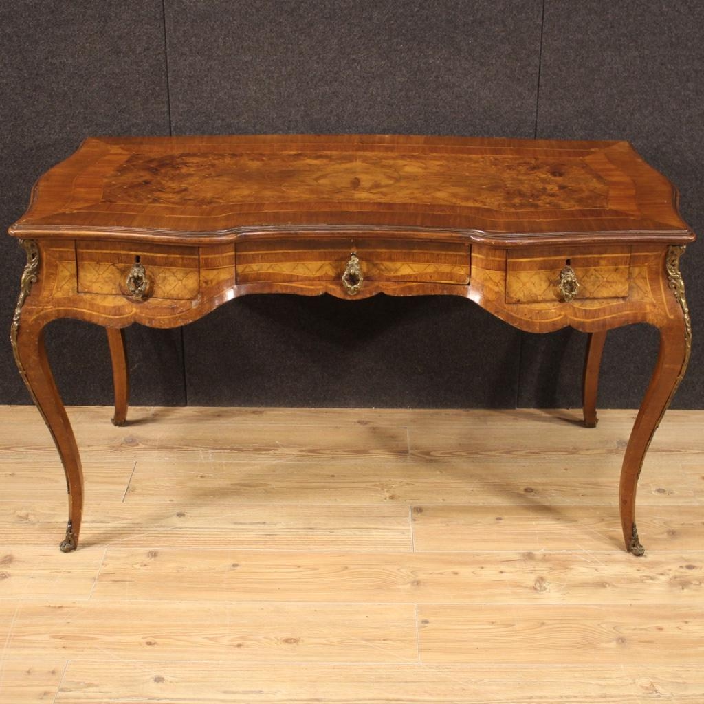 French writing desk from the mid-20th century. Furniture richly inlaid in walnut, burl, mahogany, maple, boxwood, cherry and fruitwood. Desk finished for the center adorned with chiseled bronze decorations (see photo). Furniture equipped with three