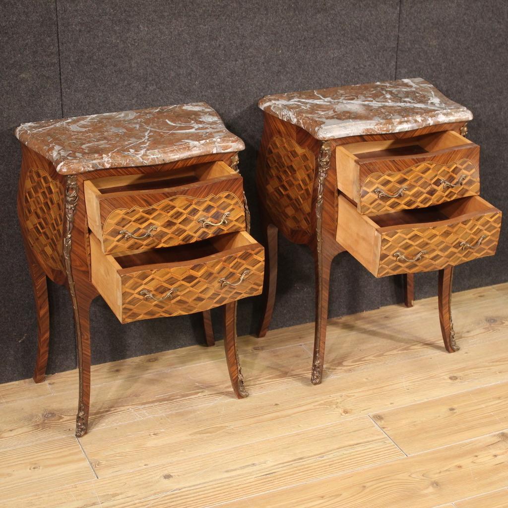Pair of French bedside tables from the second half of the 20th century. Furniture pleasantly inlaid with geometric decoration in walnut, maple, ebonized wood and fruit wood. High leg bedside tables, equipped with two drawers each, of good capacity.