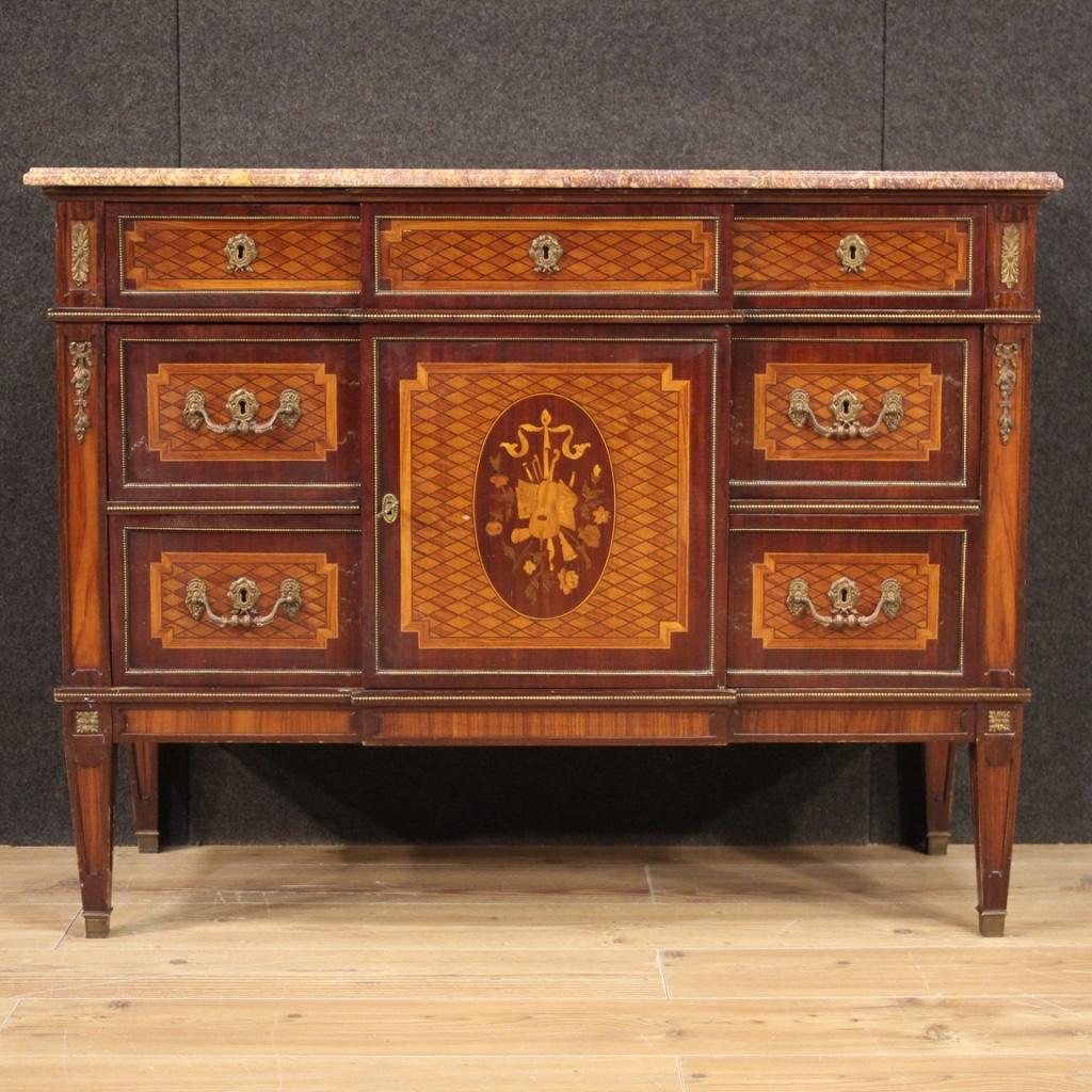 French chest of drawers from the mid 20th century. High quality furniture adorned with geometric inlay in mahogany, walnut, maple and fruitwood. Louis XVI style dresser richly decorated with bronze and gilded and chiseled brass (see photo).