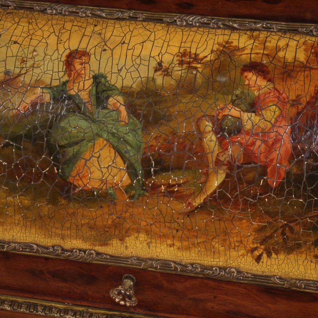 French bureau from the first half of the 20th century. Napoleon III style furniture inlaid with geometric decorations in mahogany and fruitwood, frontally adorned with a romantic painting with characters of great pleasure. Roll-top bureau equipped