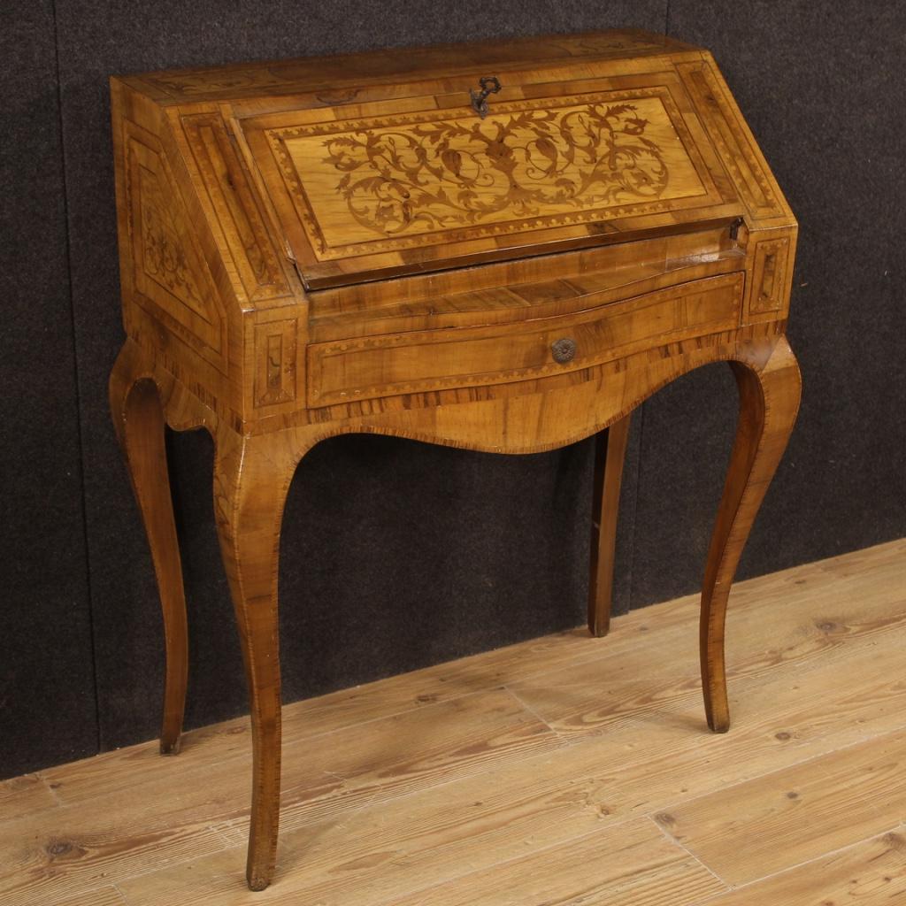 Italian bureau from the mid-20th century. Beautifully designed furniture inlaid in walnut, burl, maple, rosewood, beech and fruitwood. Bureau with high leg equipped with an external drawer and fall-front, of good capacity and service. Interior