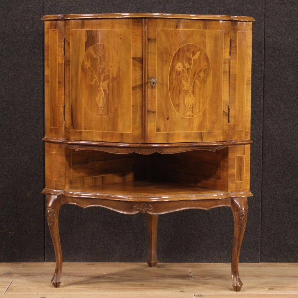 Italian corner cabinet from 20th century. Inlaid and carved furniture in walnut, maple and beech woods. Corner cupboard equipped with two doors and an open compartment (see photo) of good capacity. Wooden top in character, cabinet complete with a